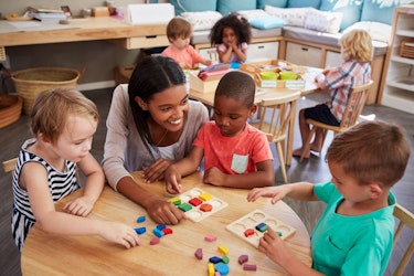 Montessori classroom with kids playing and smiling