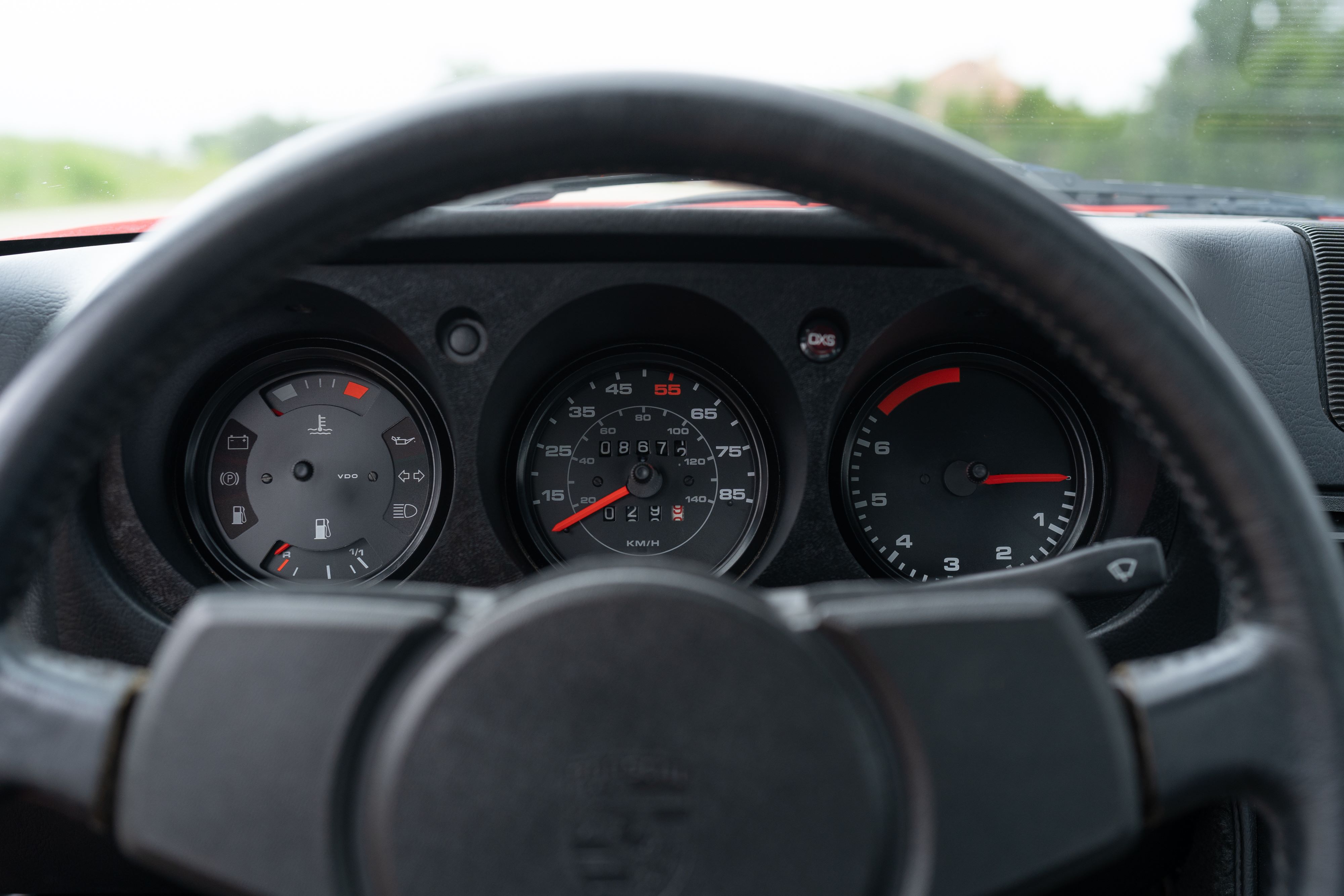 Gauges on a Guards Red Porsche 924 Turbo in Dripping Springs, TX.