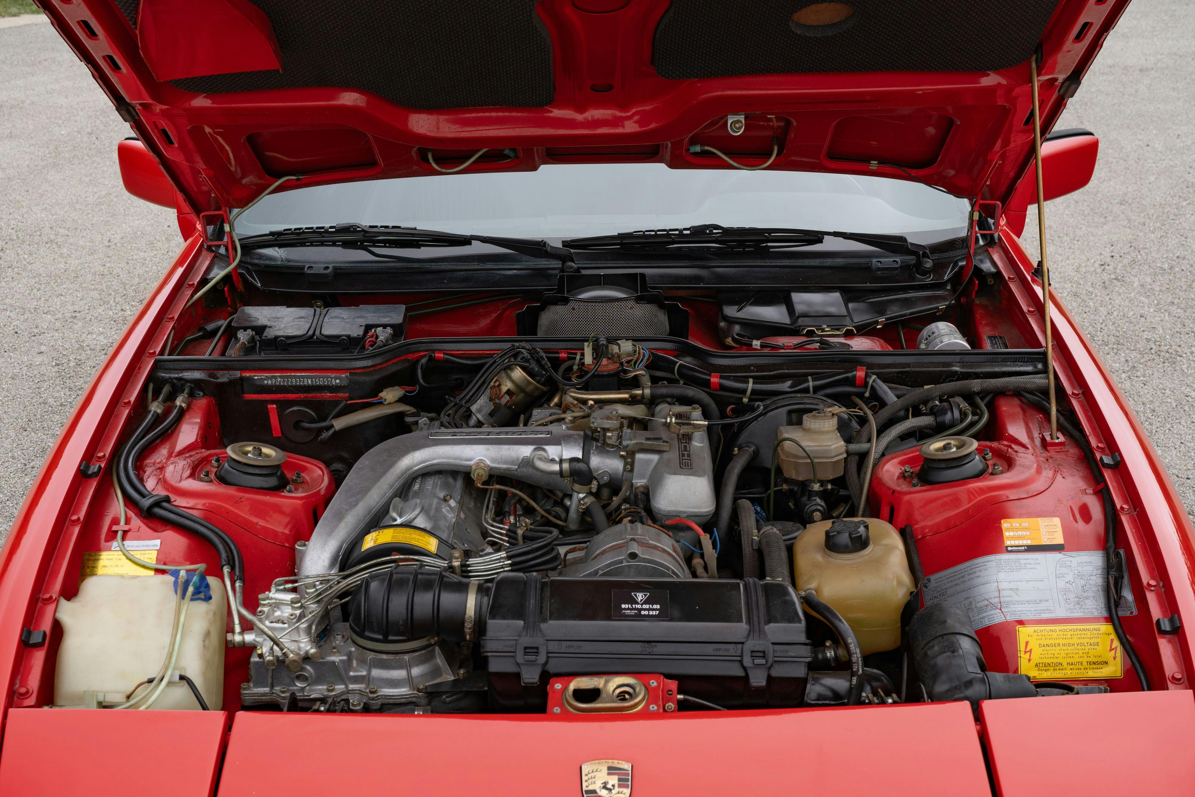 Engine bay of a Guards Red Porsche 924 Turbo in Dripping Springs, TX.