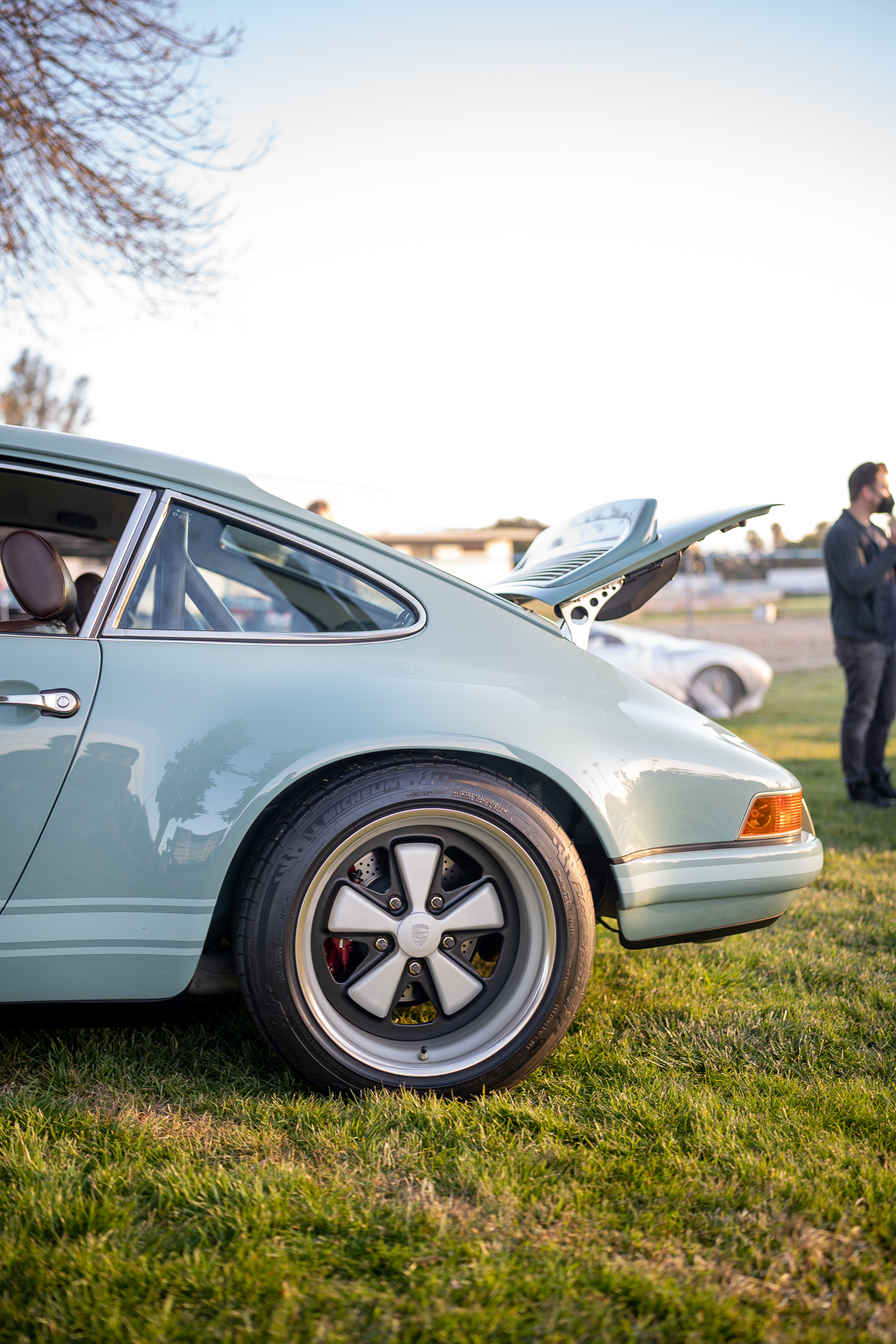 Rear end of a light blue Singer 911