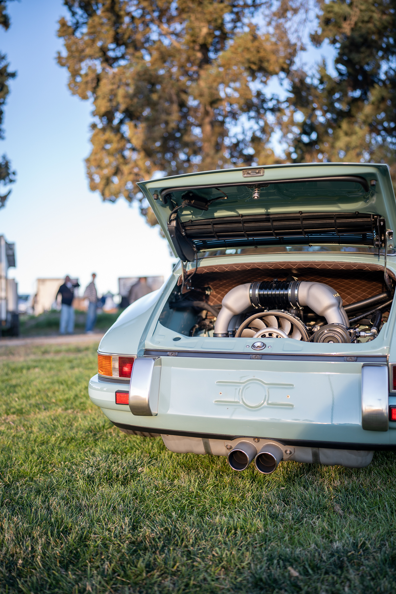 Engine bay of a light blue Singer 911