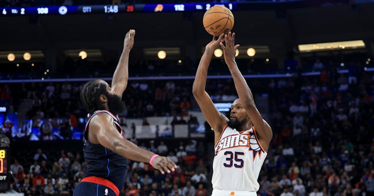 Kevin Durant shooting over James Harden.