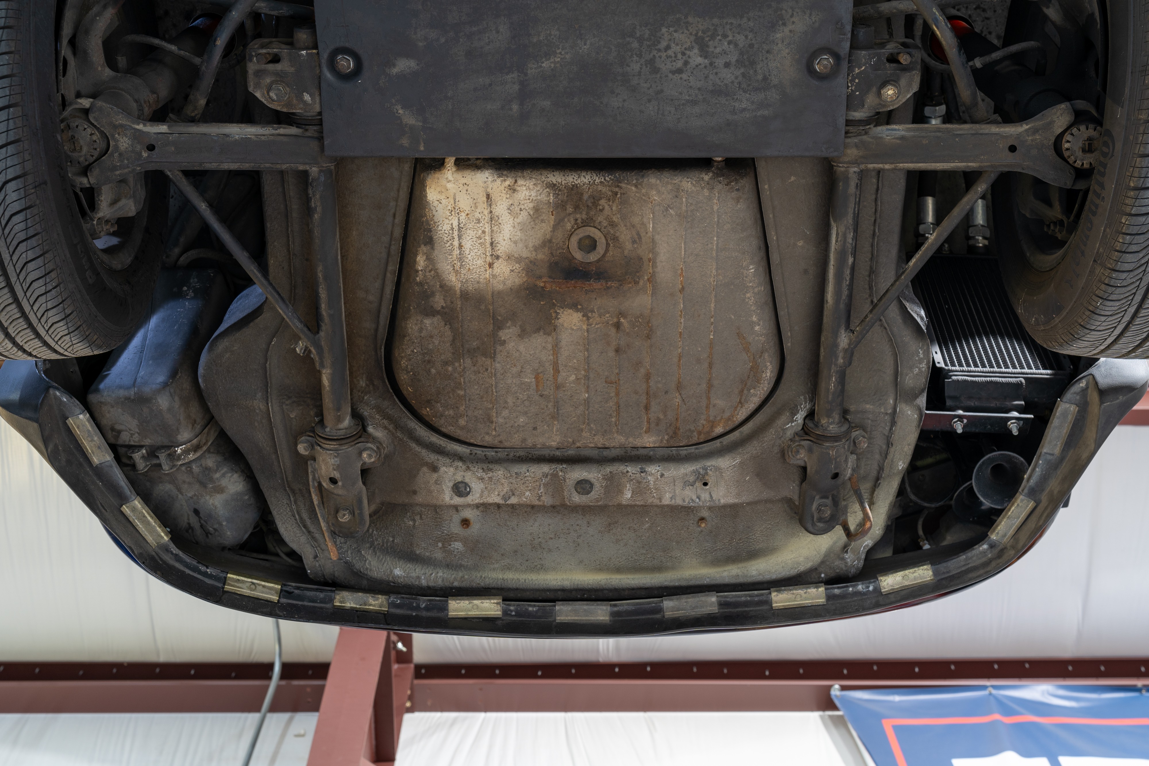 Undercarriage shots of a 1976 Porsche 911S Sportomatic in Black on Cinnamon.