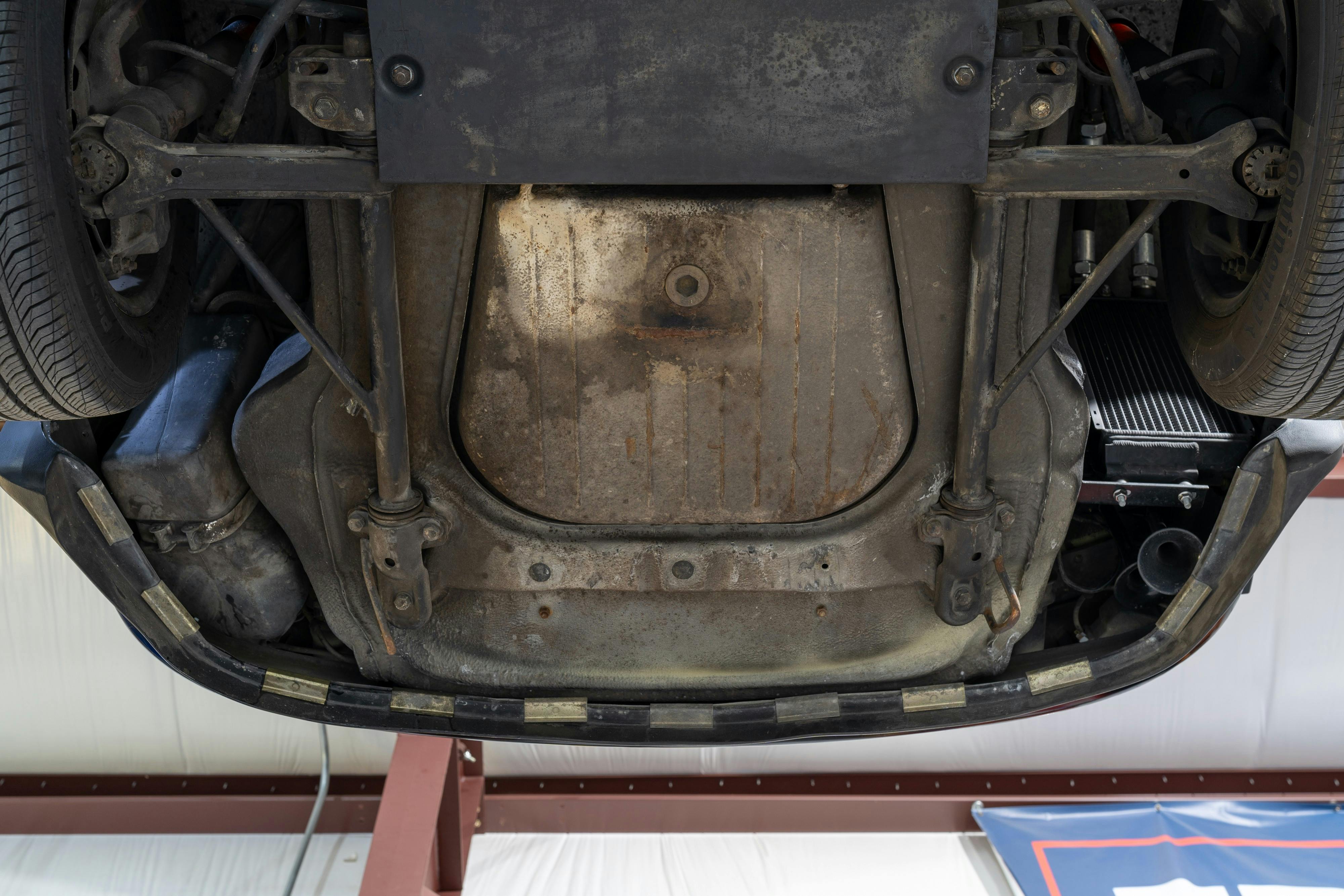 Undercarriage shots of a 1976 Porsche 911S Sportomatic in Black on Cinnamon.