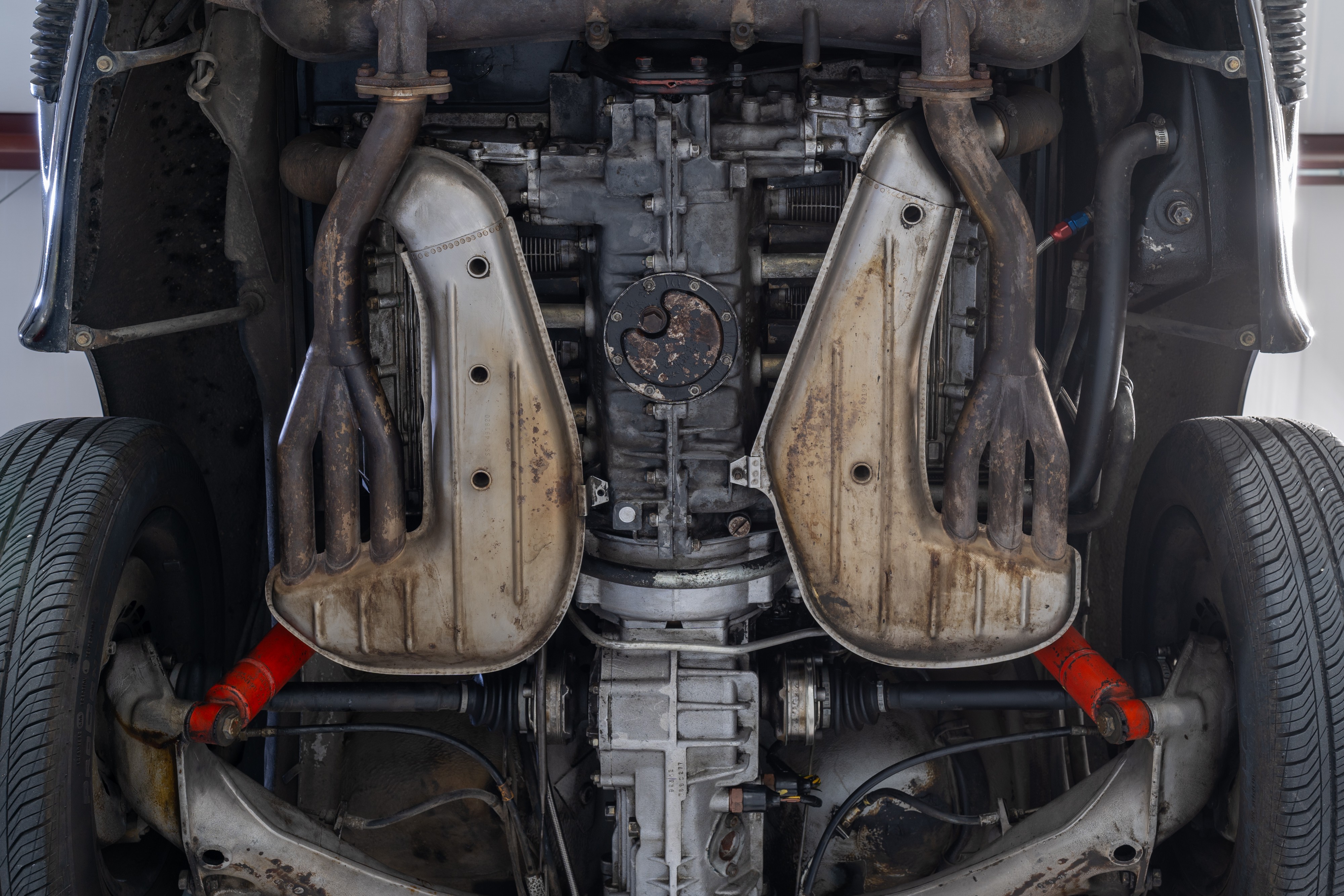 Undercarriage shots of a 1976 Porsche 911S Sportomatic in Black on Cinnamon.