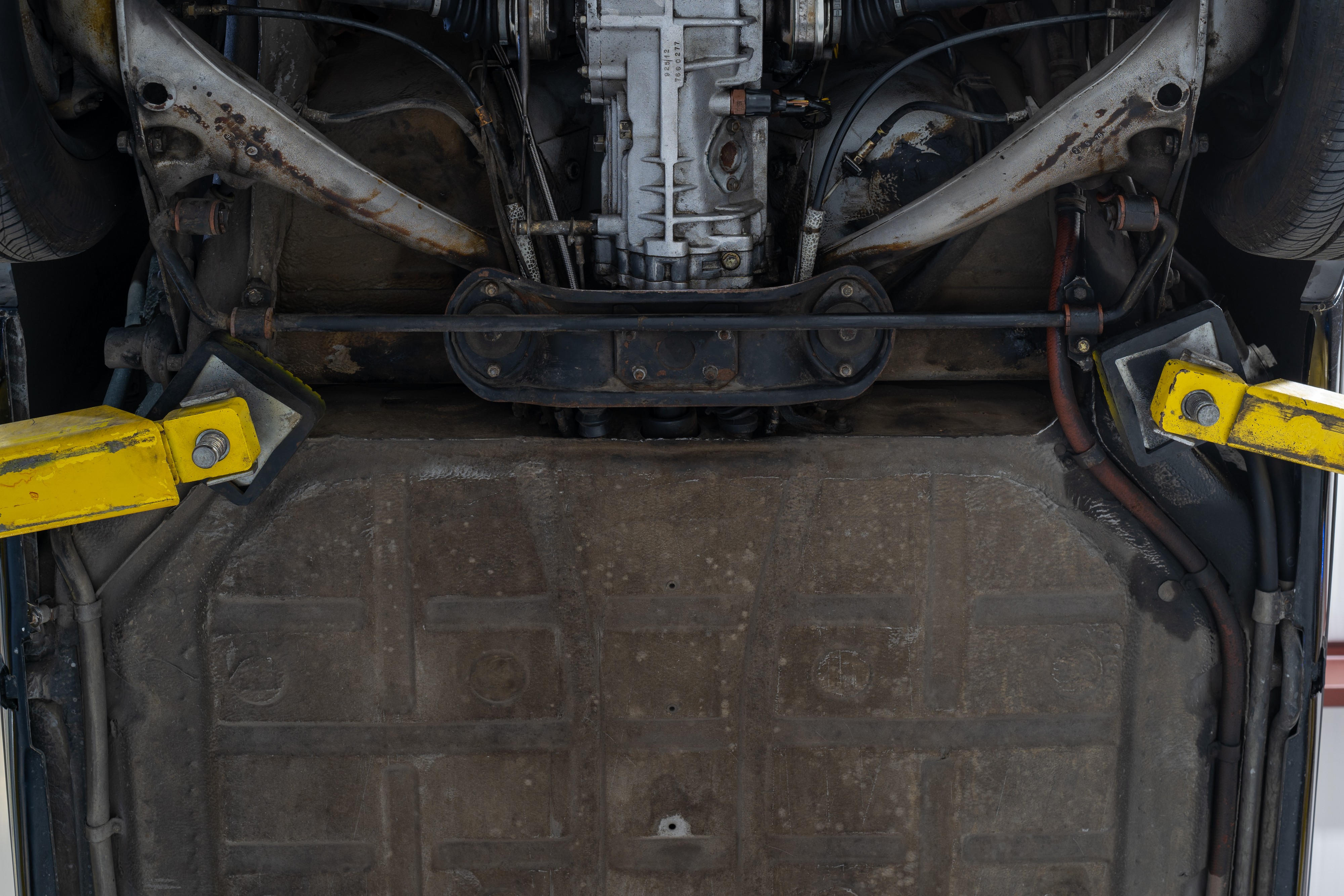 Undercarriage shots of a 1976 Porsche 911S Sportomatic in Black on Cinnamon.