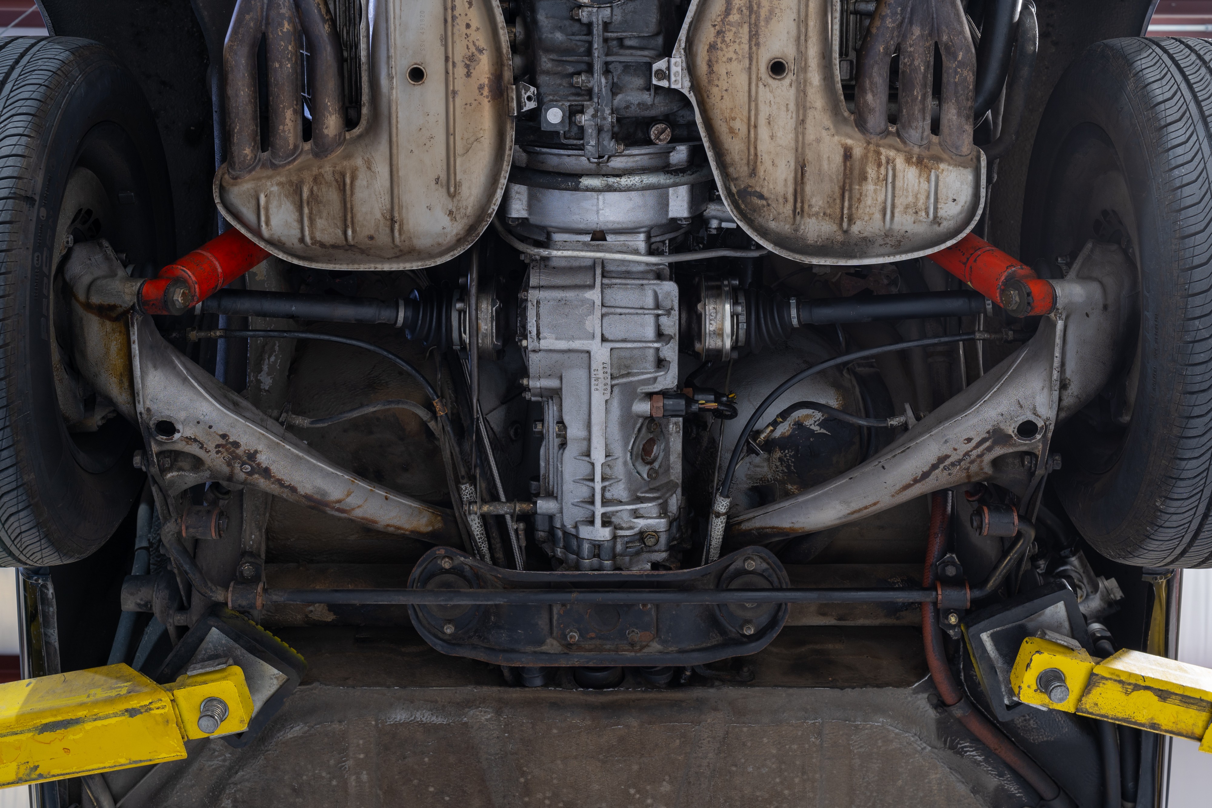 Undercarriage shots of a 1976 Porsche 911S Sportomatic in Black on Cinnamon.