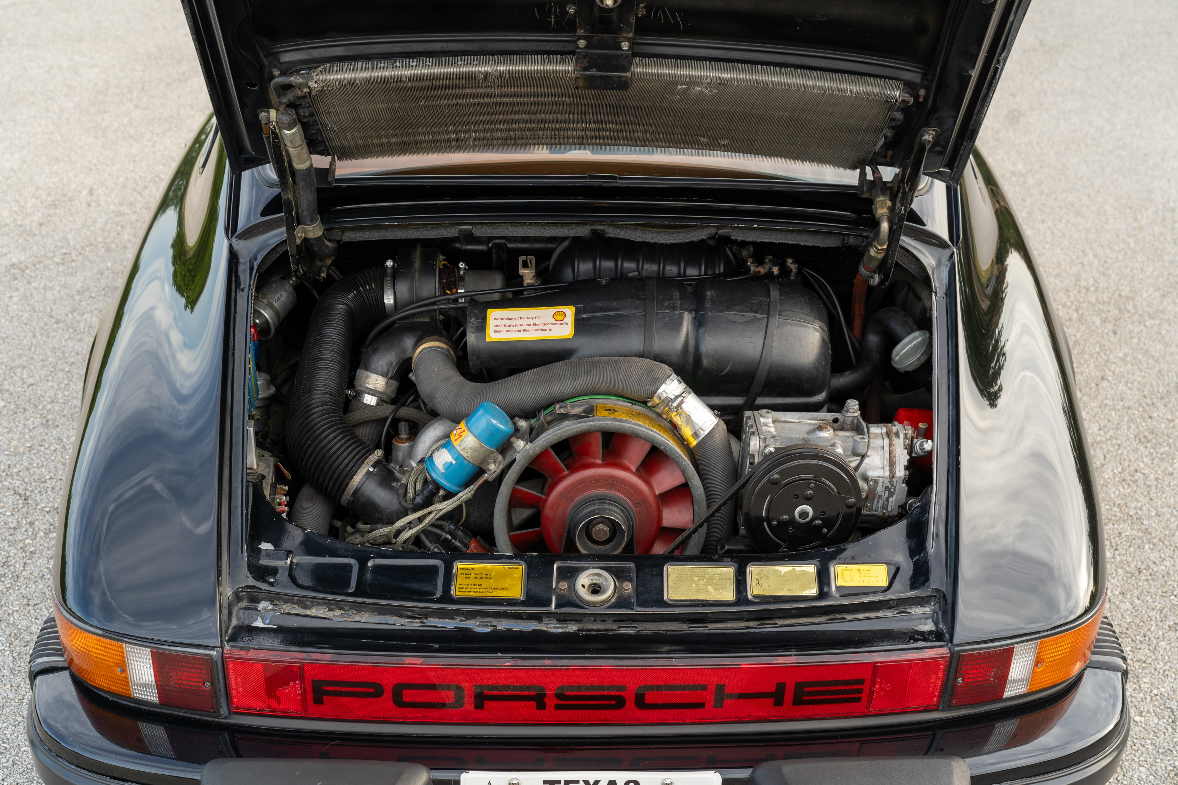 Engine bay of a 1976 Porsche 911S Sportomatic in Black on Cinnamon.