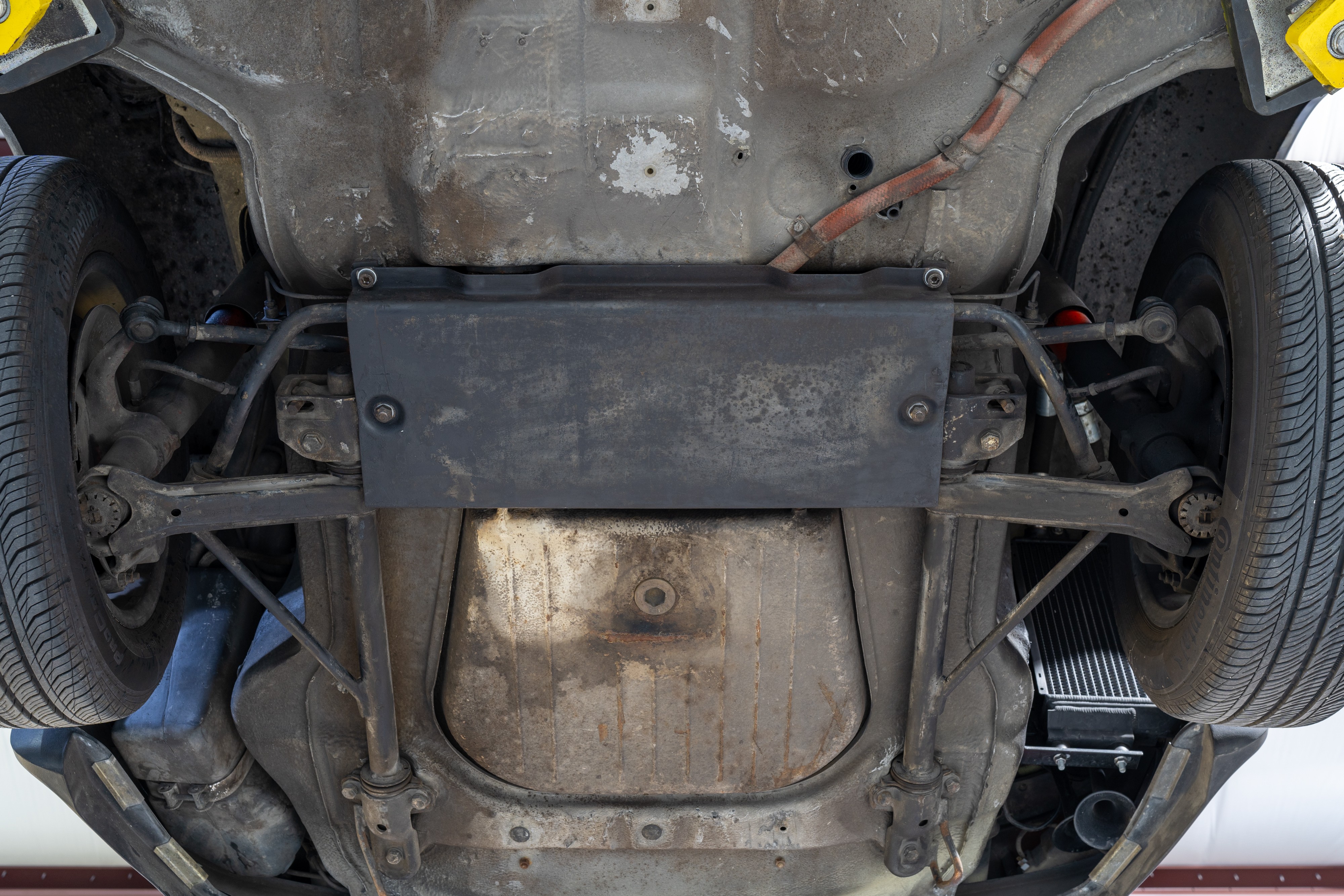 Undercarriage shots of a 1976 Porsche 911S Sportomatic in Black on Cinnamon.