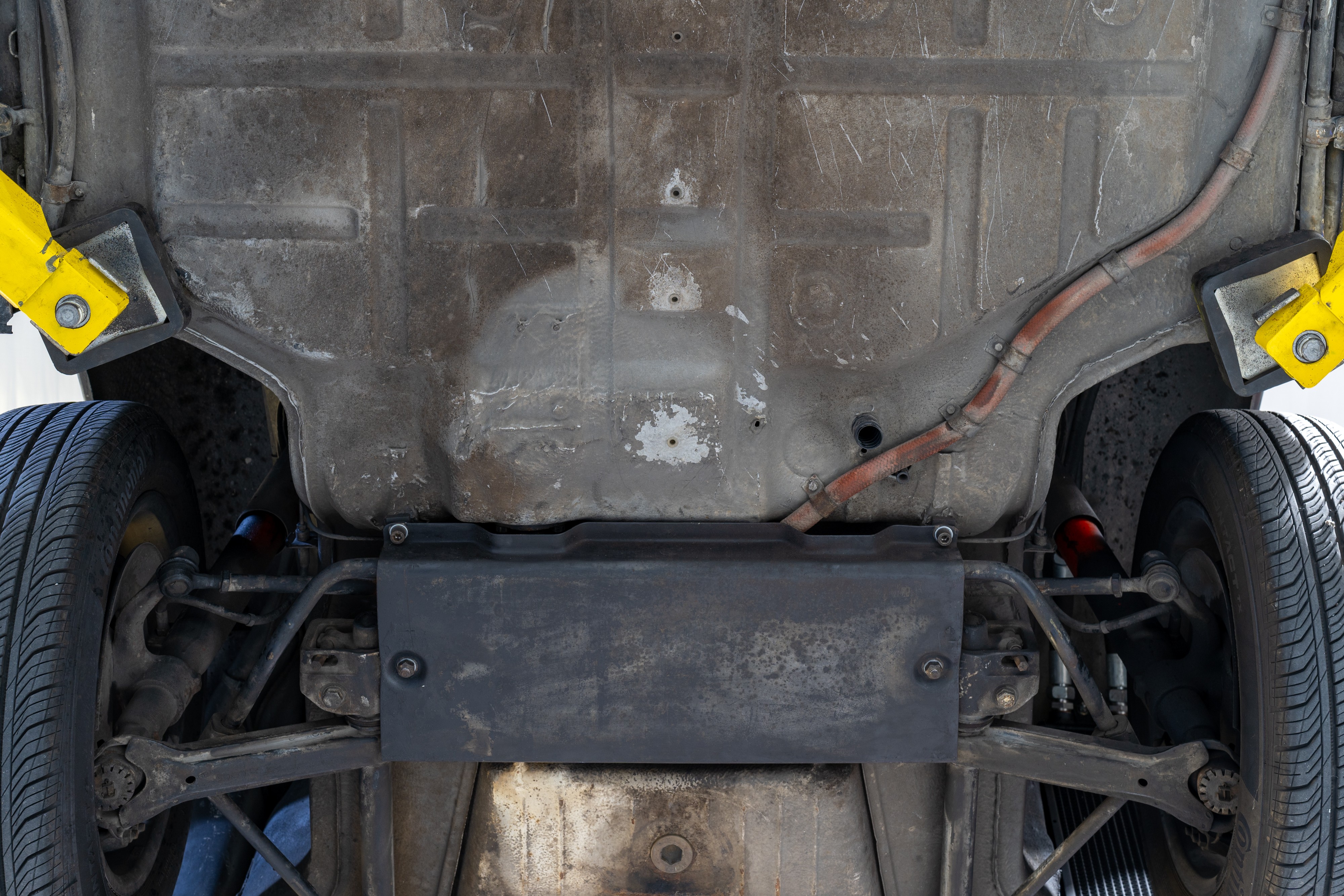 Undercarriage shots of a 1976 Porsche 911S Sportomatic in Black on Cinnamon.