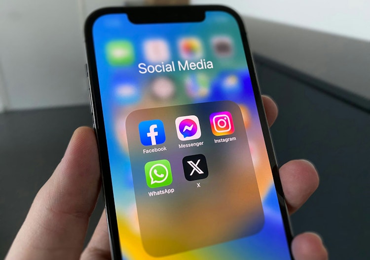 Phone representing reports Meta is developing a Prediction Markets app.