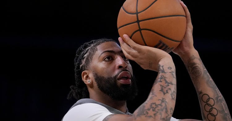 Anthony Davis shooting a jump shot in warm up gear.