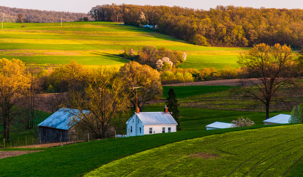 Photo of a farmhouse in Pennsylvania nestled into rolling hills
