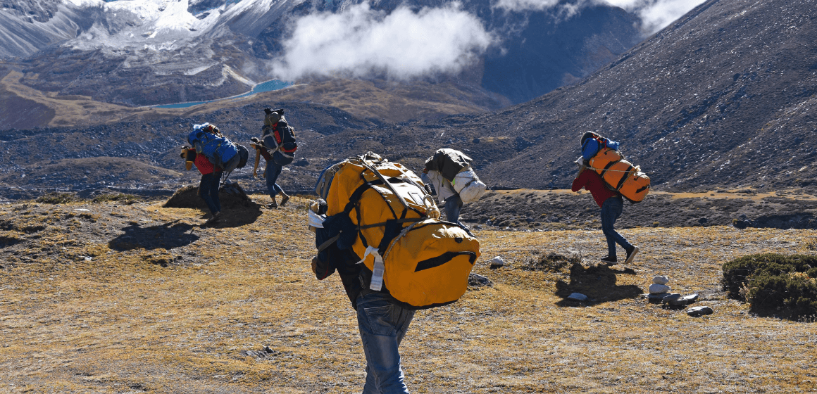 Porters-carrying-gear-on-EBC.png
