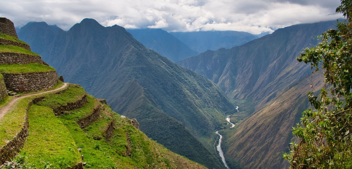 Mountain-peaks-and-a-narrow-lake-seen-from-the-Inca-Trail---The-Adventure-People.png