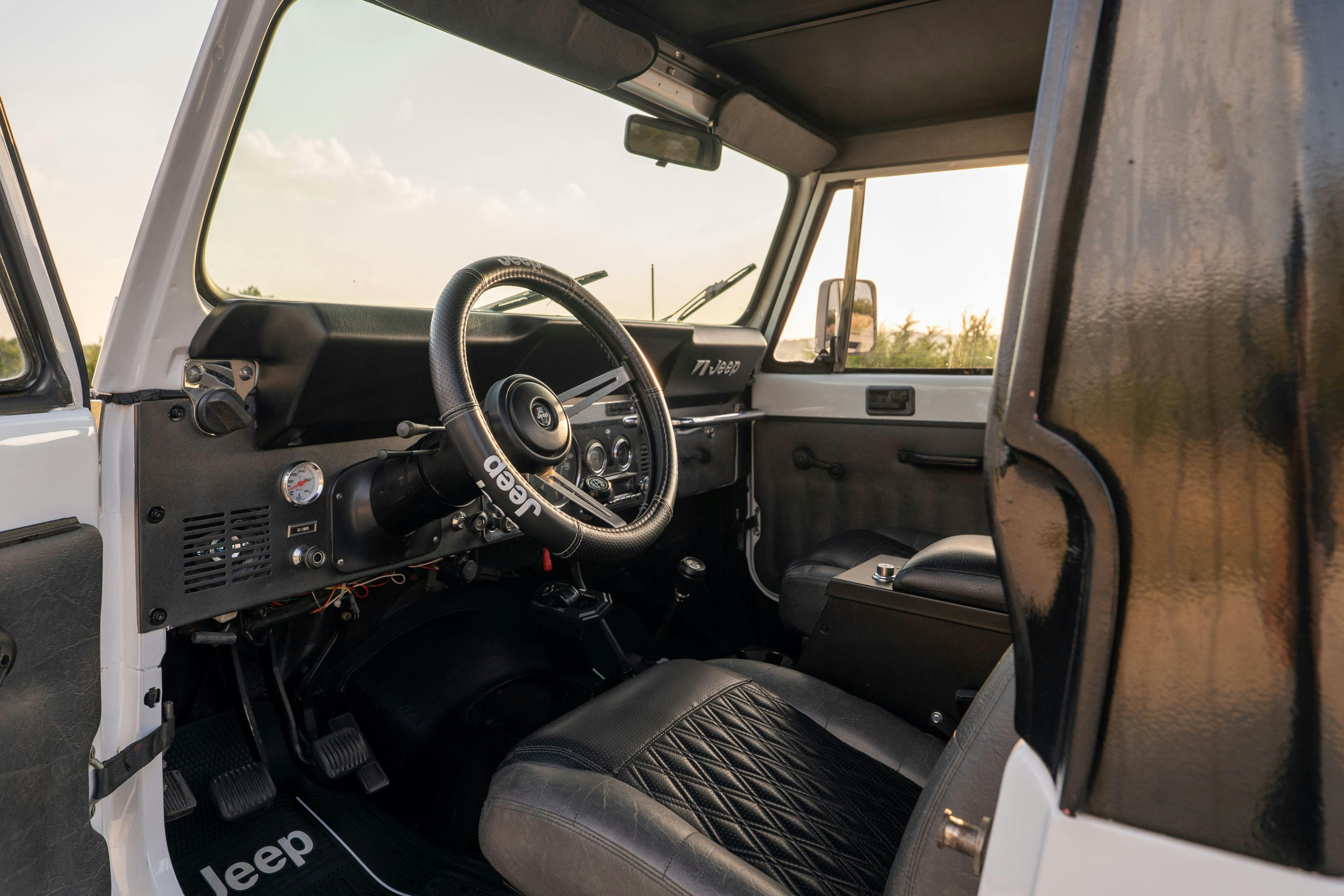 The interior of a 1983 Jeep Scrambler in White on Black in Austin, TX.