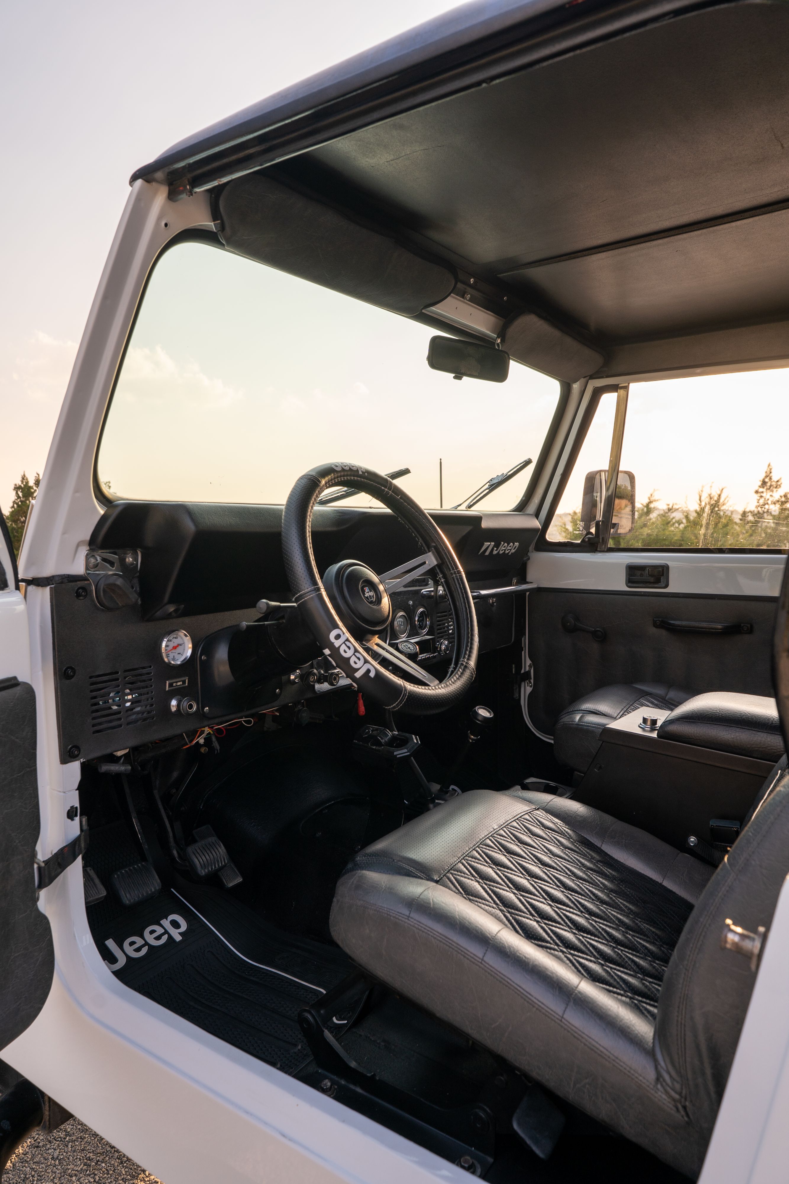 The interior of a 1983 Jeep Scrambler in White on Black in Austin, TX.