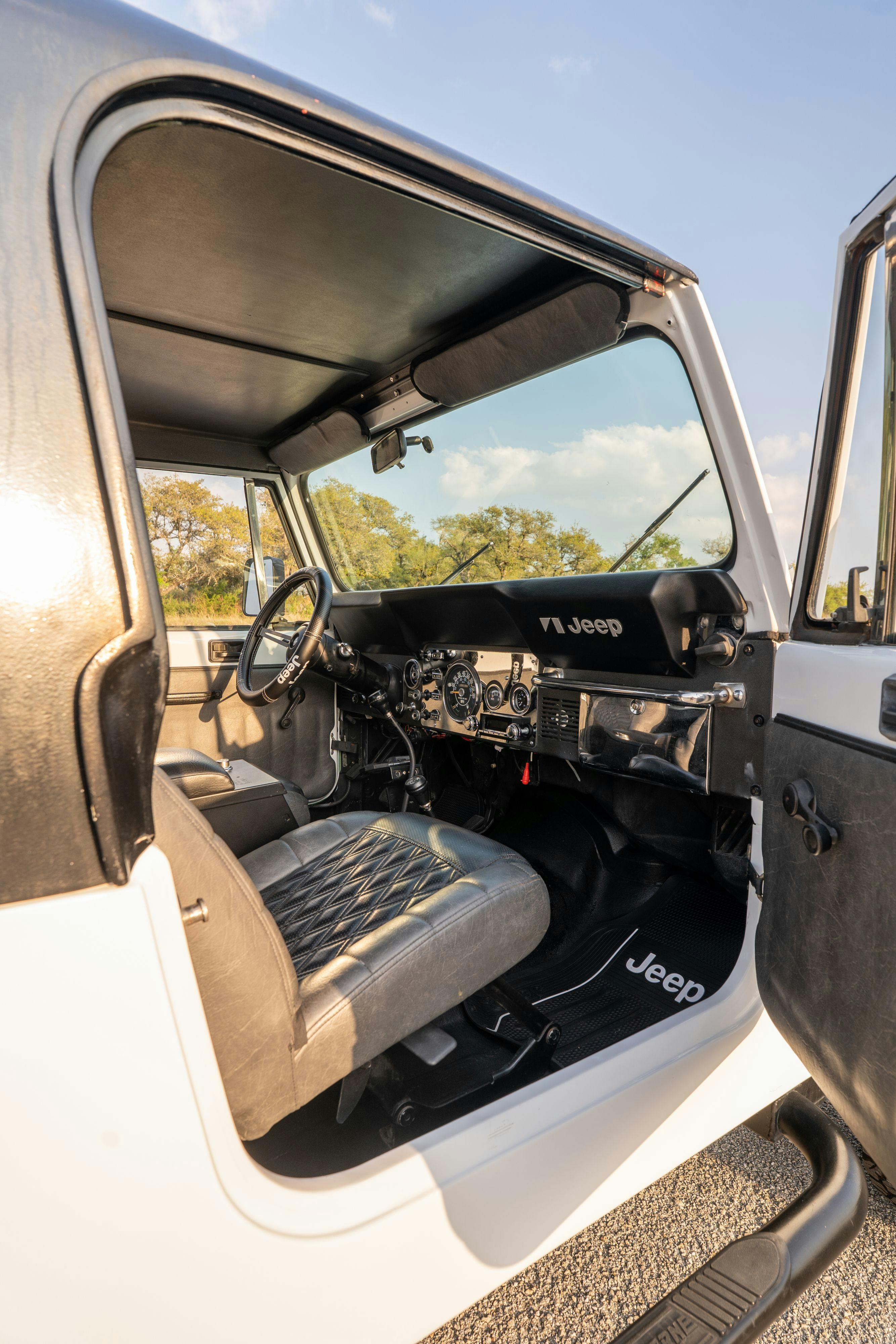 The interior of a 1983 Jeep Scrambler in White on Black in Austin, TX.