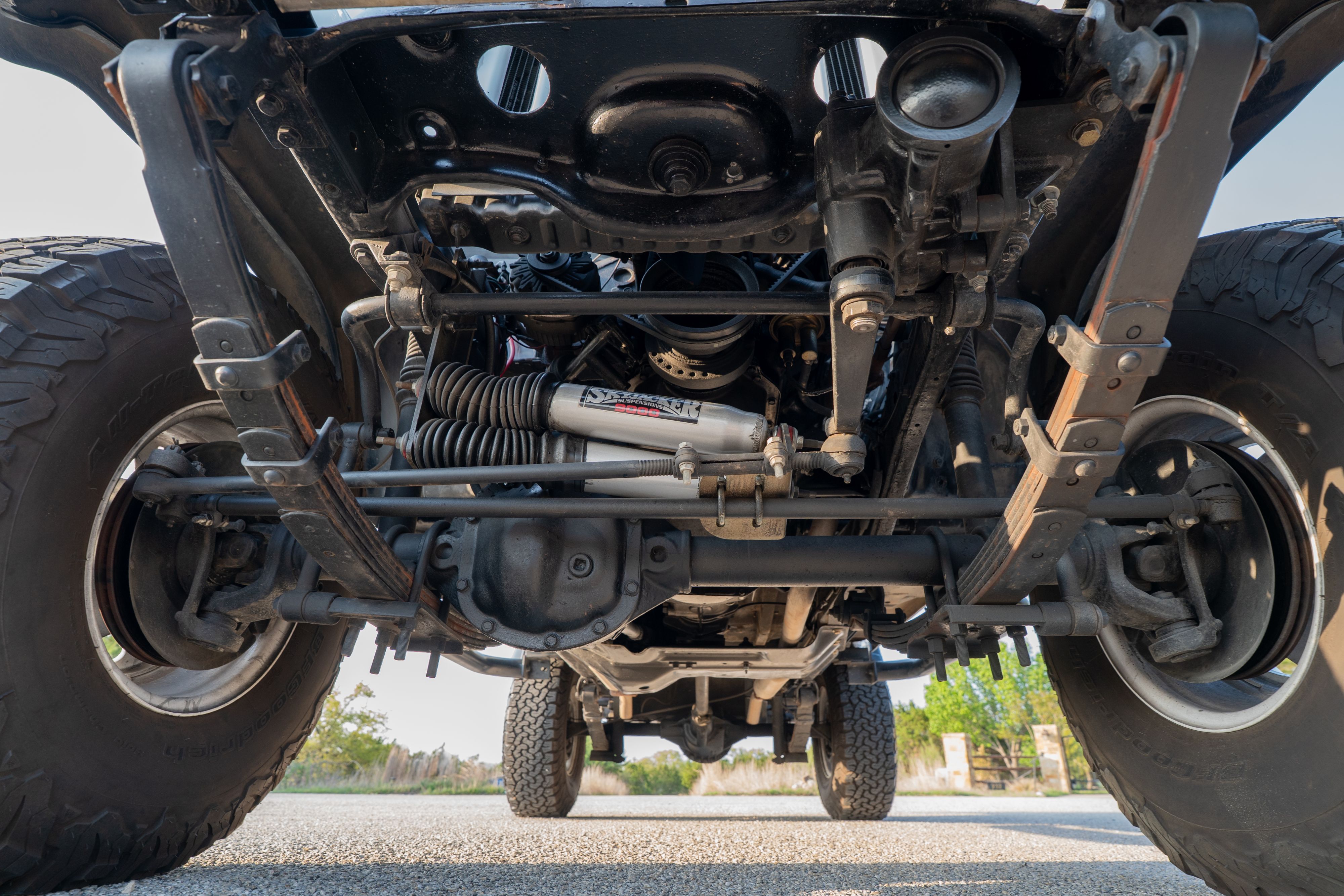 Underside of a 1983 Jeep Scrambler in White on Black in Austin, TX.