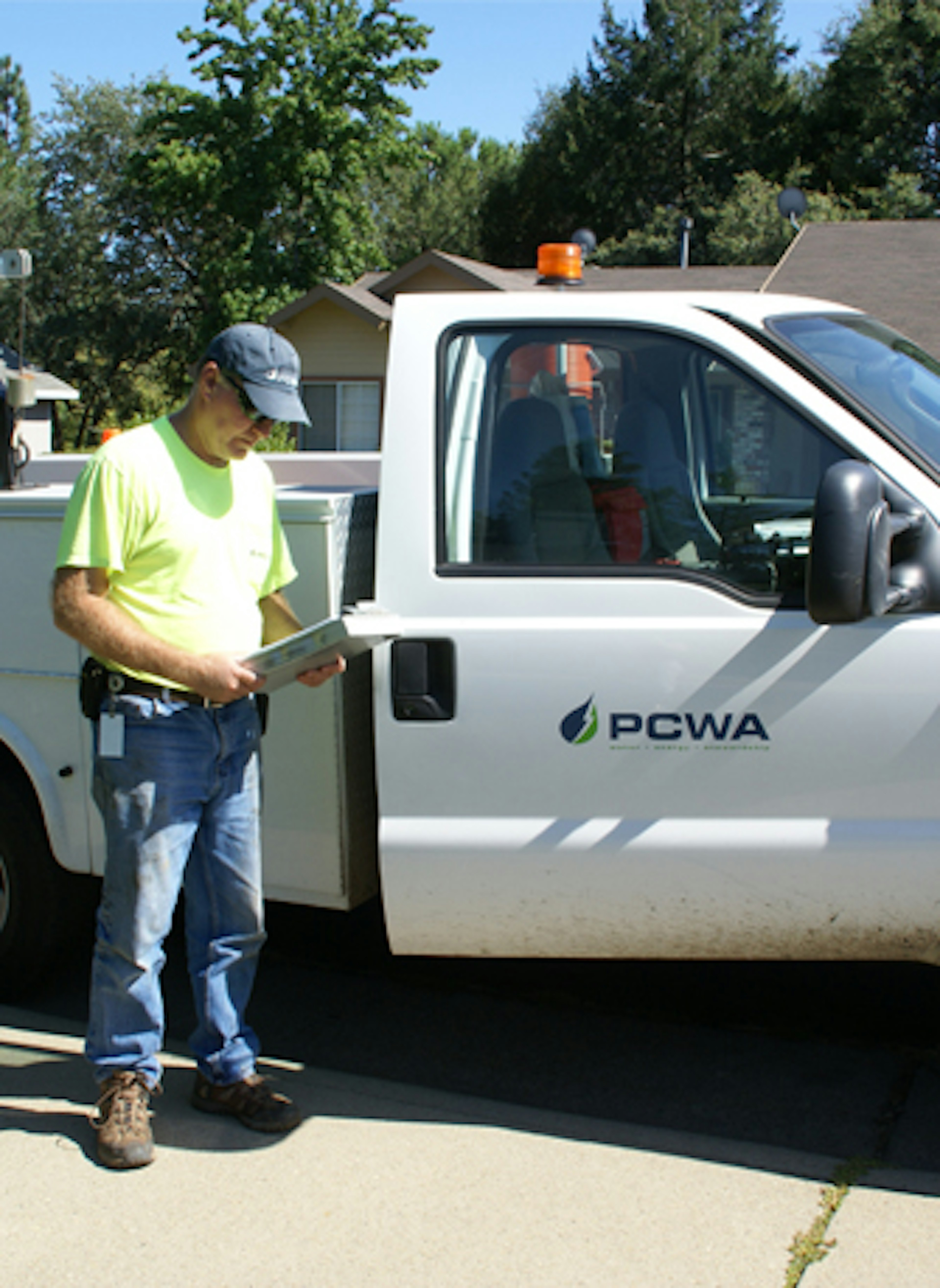 A photo of a PCWA Employee near an identified PCWA service truck