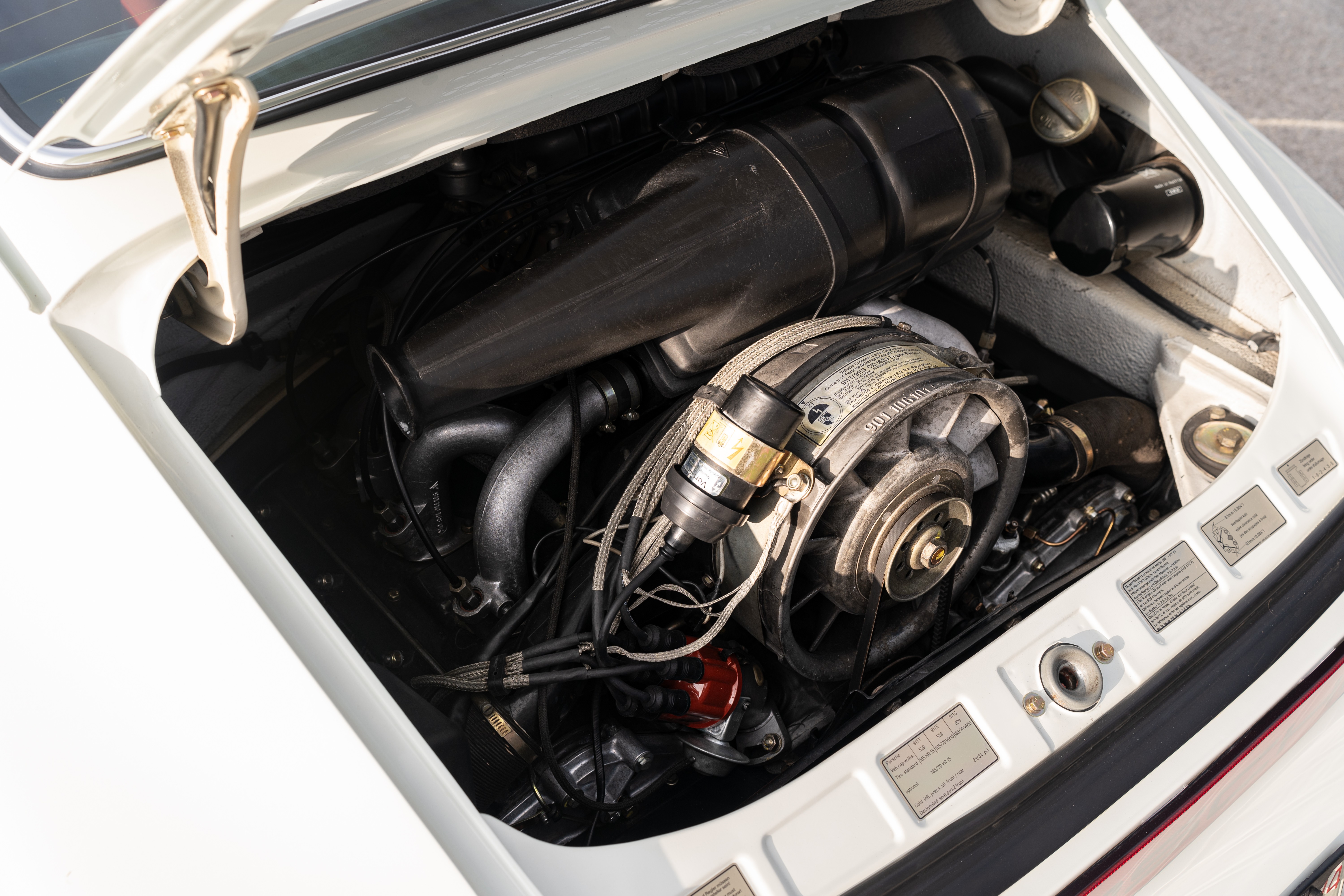 Engine bay on a White on Red 1974 Porsche 911 Coupe 5-Speed shot in Austin, TX.