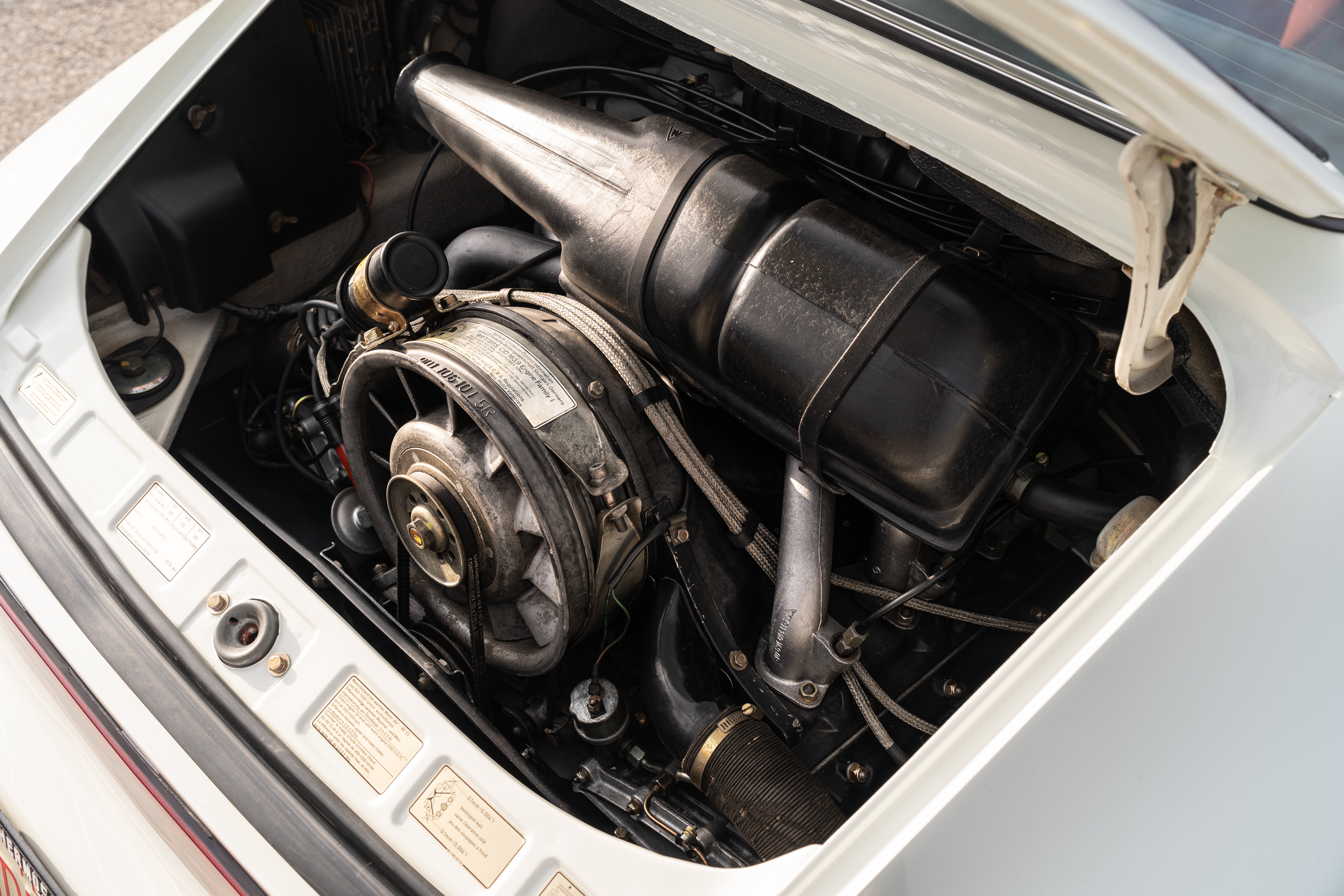 Engine bay on a White on Red 1974 Porsche 911 Coupe 5-Speed shot in Austin, TX.