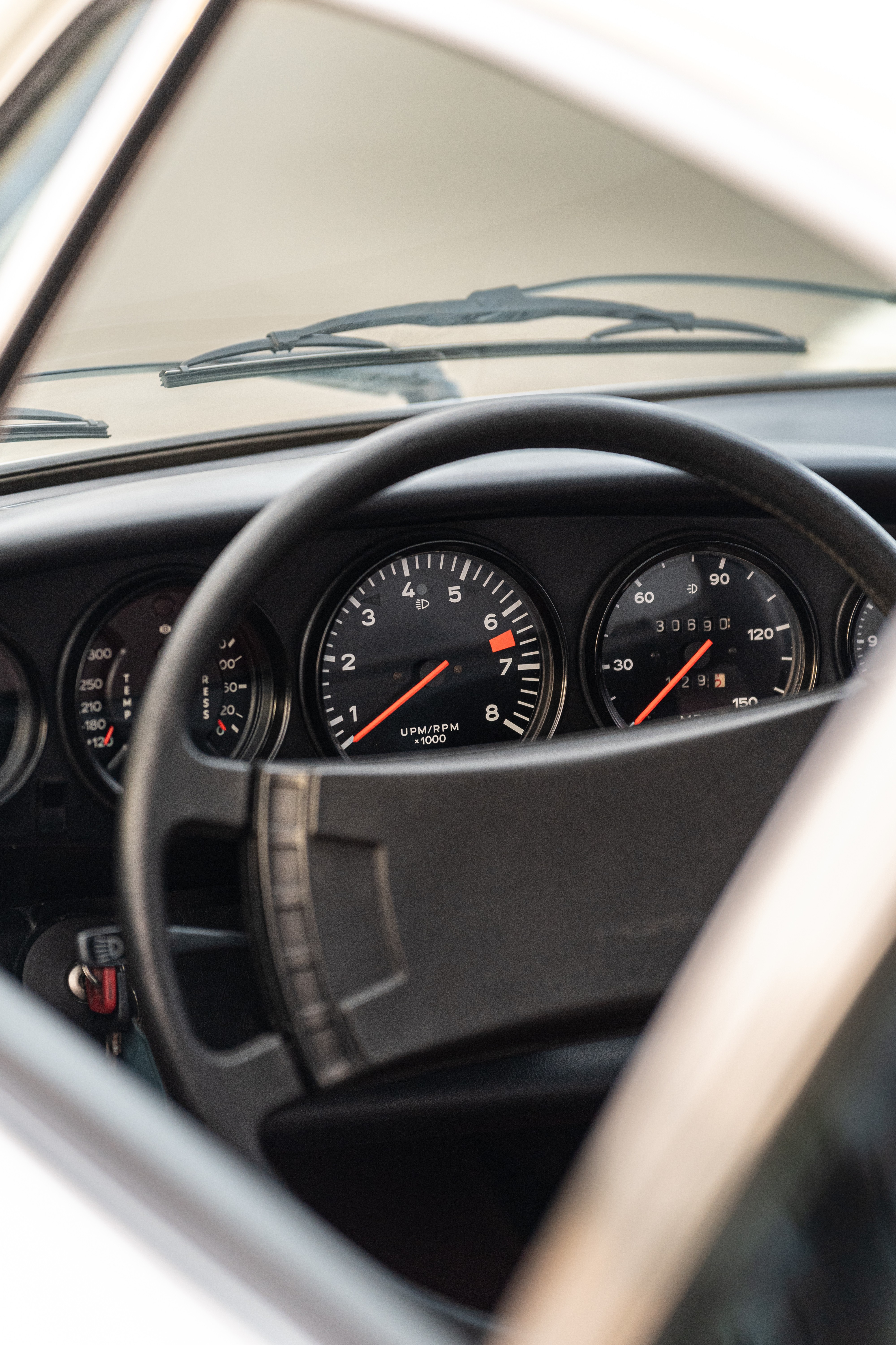 Tachometer on a White on Red 1974 Porsche 911 Coupe 5-Speed shot in Austin, TX.