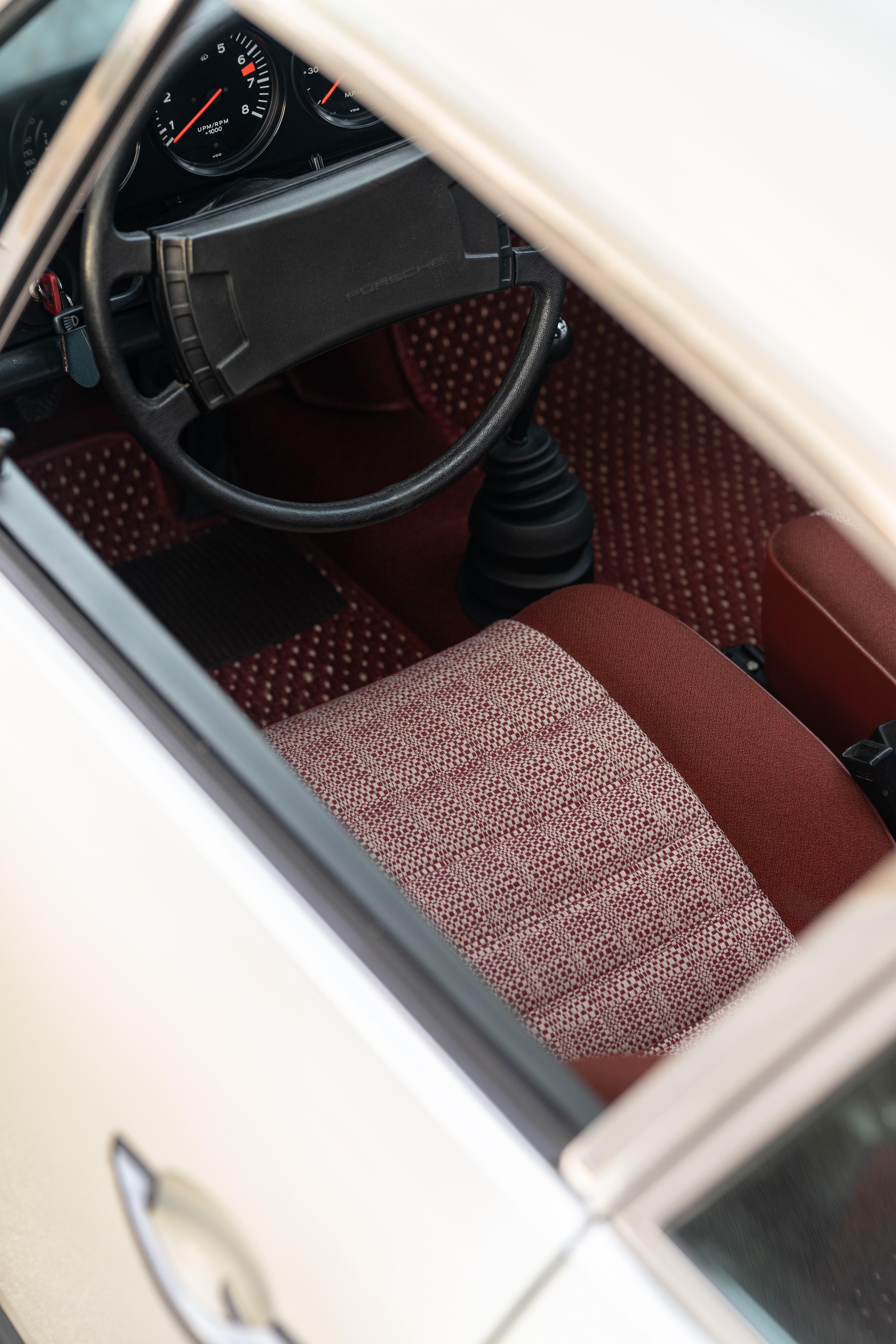 1974 Porsche 911 Coupe 5-Speed with red tweed and CoCo floor mats.