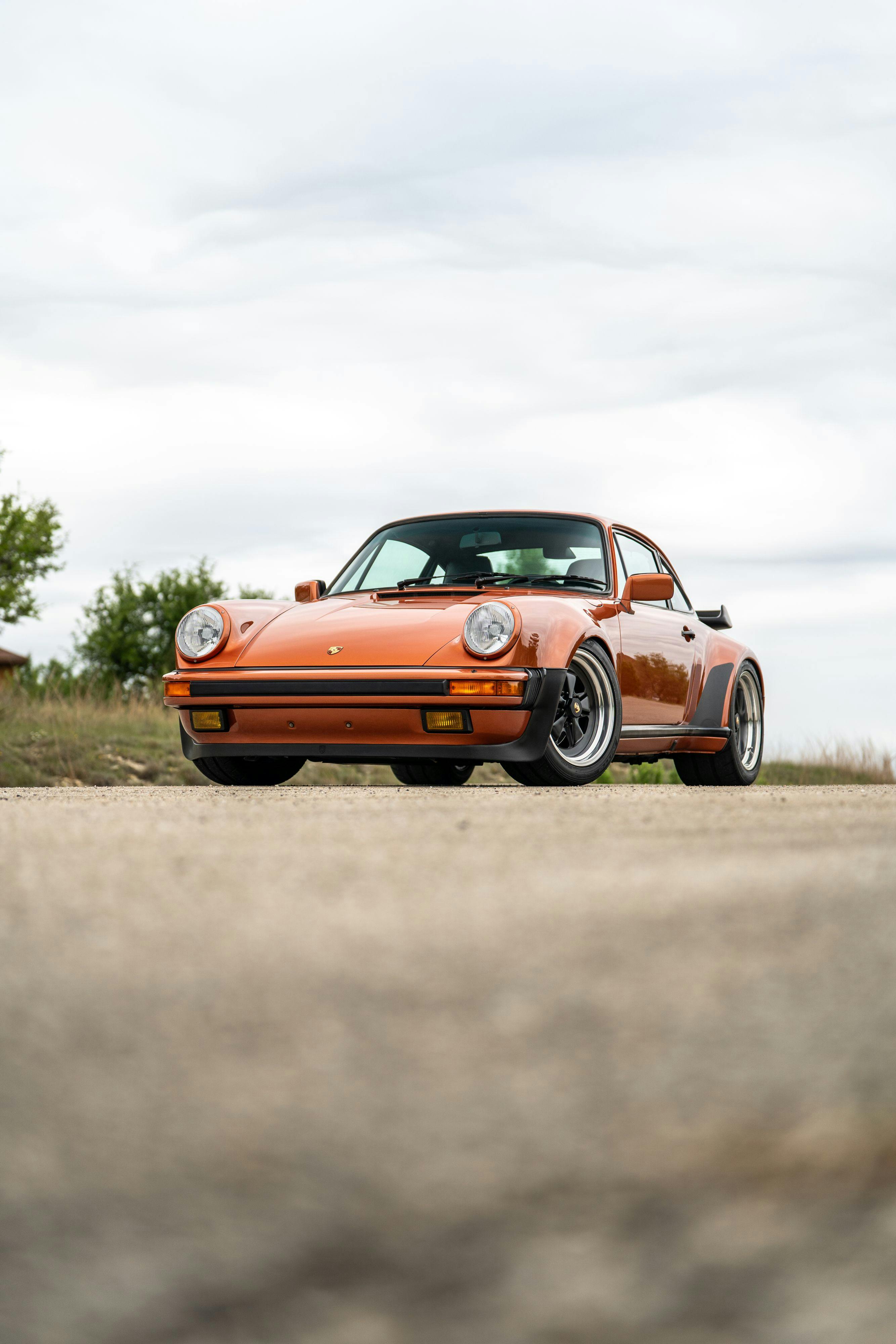 1986 Porsche 930 Turbo in Metallic Orange over Black.