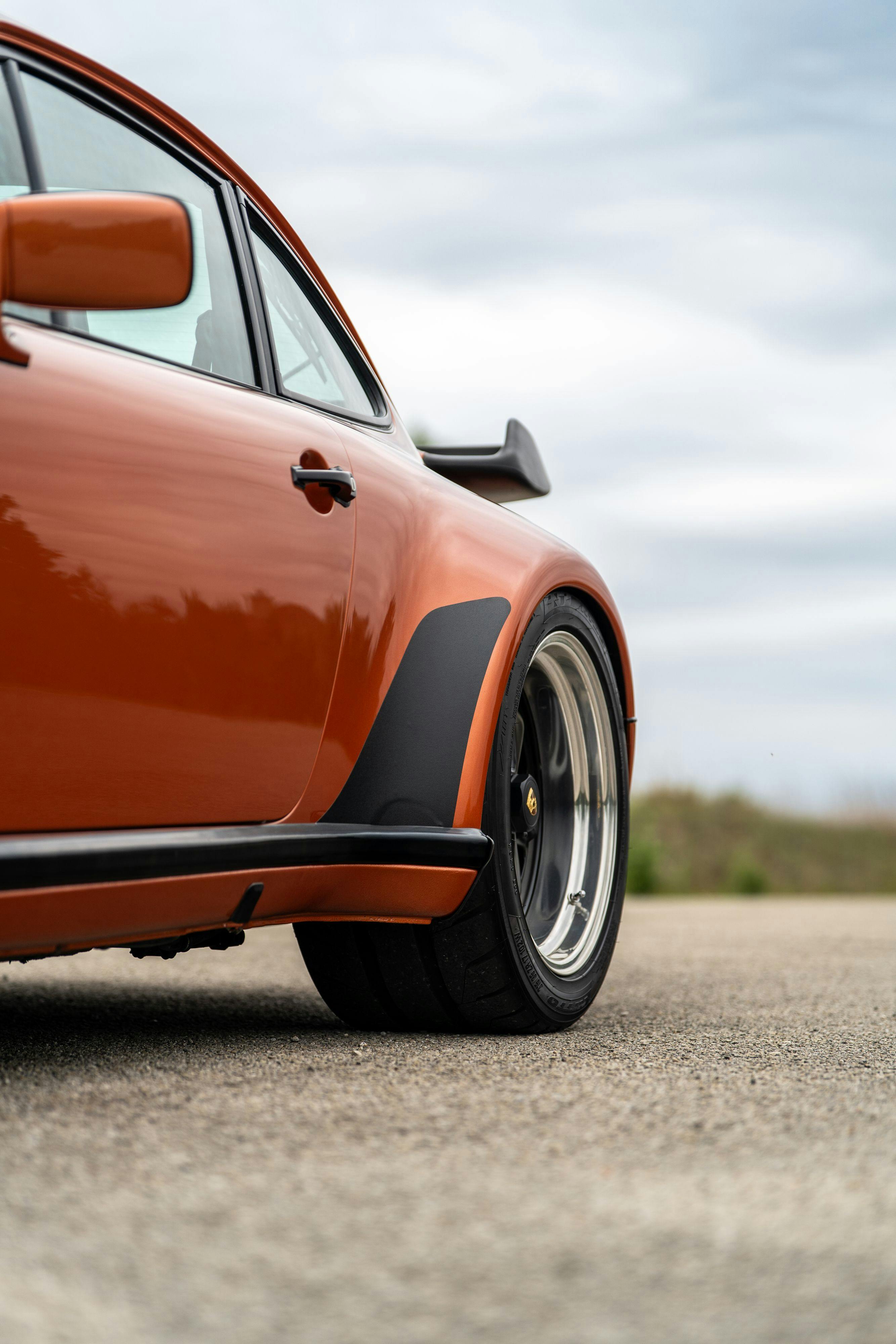1986 Porsche 930 Turbo in Metallic Orange over Black.