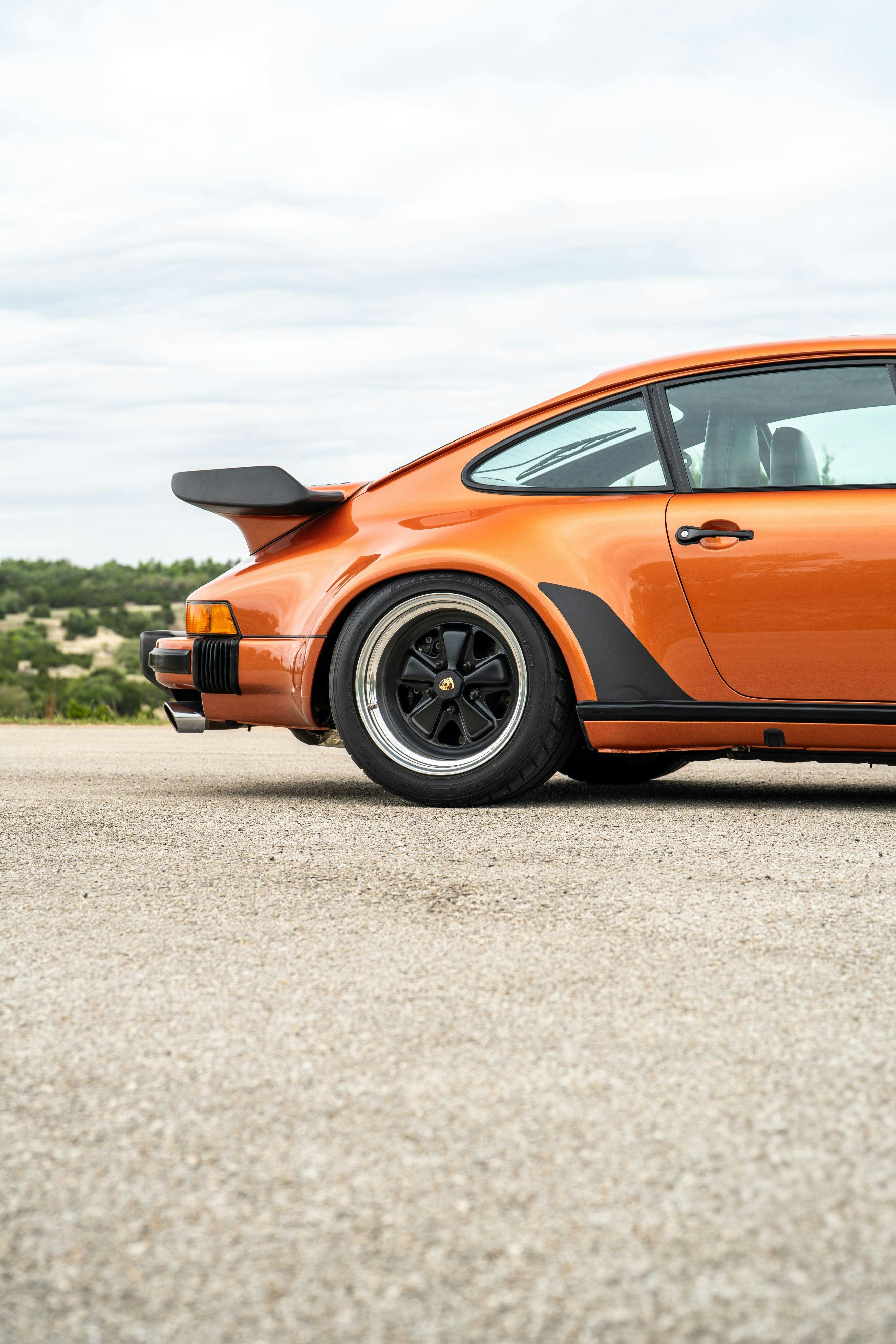 1986 Porsche 930 Turbo in Metallic Orange over Black.