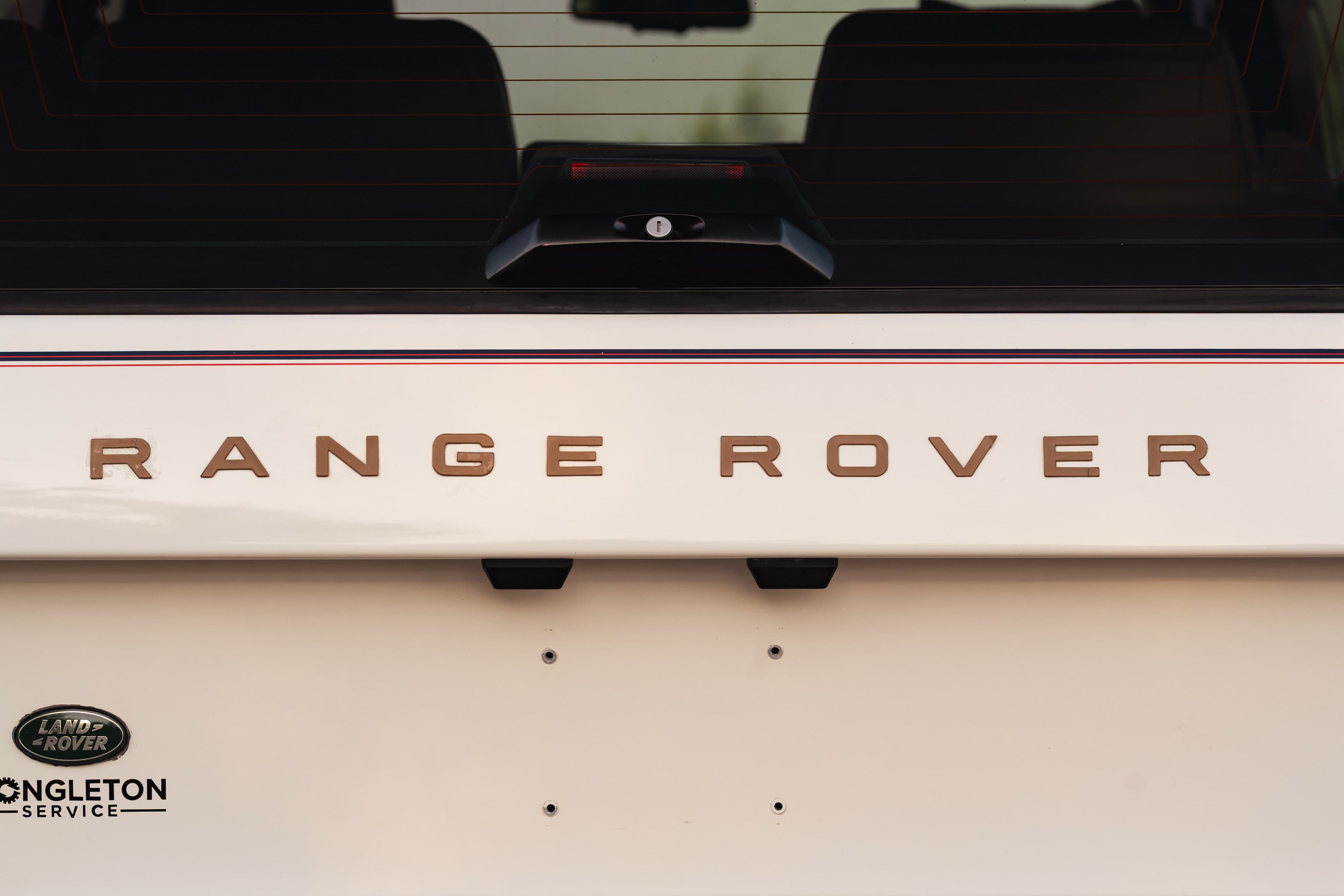 Badging on a 1995 White Land Rover Range Rover County Long Wheel Base in Austin, TX.