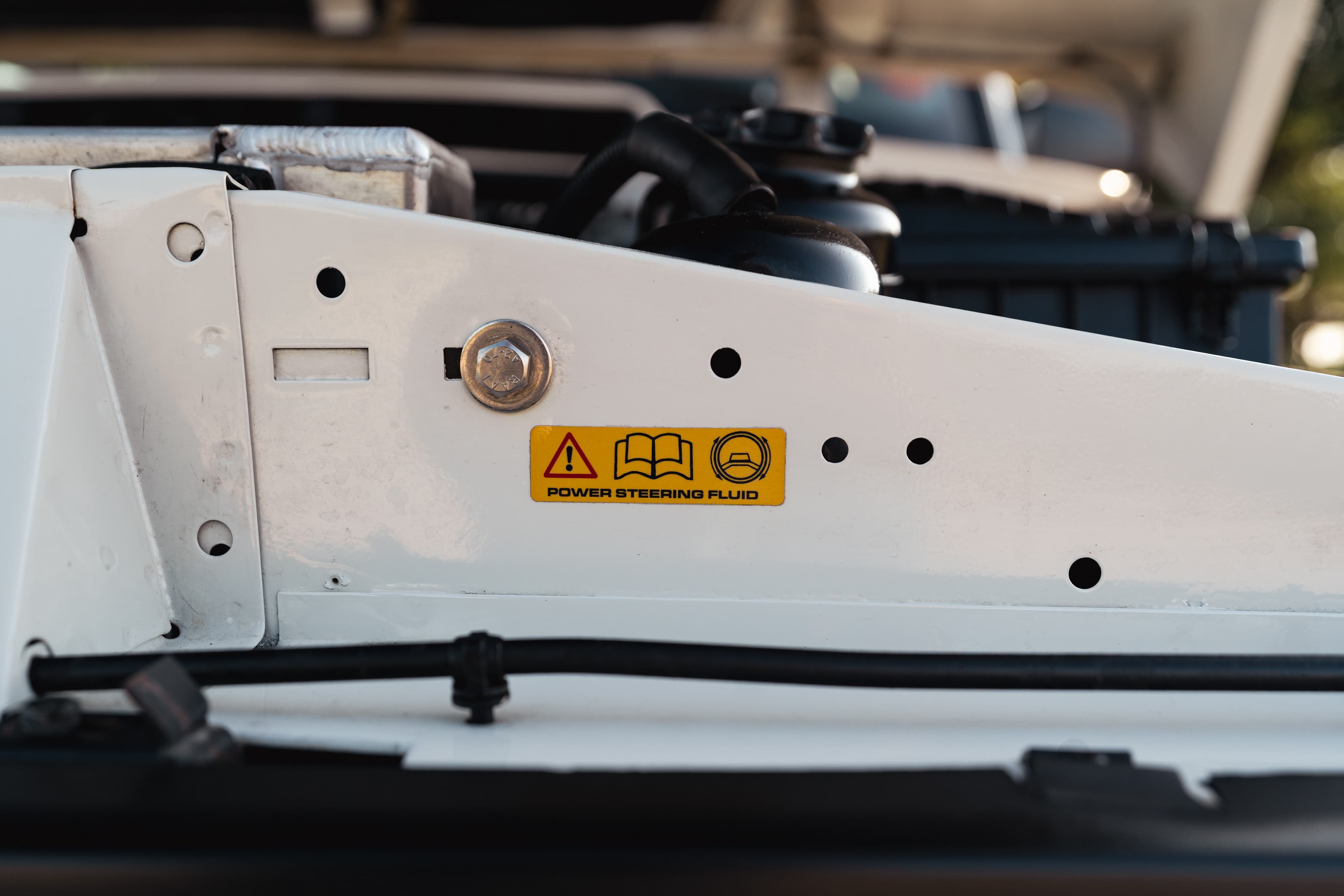 Engine bay stickers on a 1995 White Land Rover Range Rover County Long Wheel Base in Austin, TX.