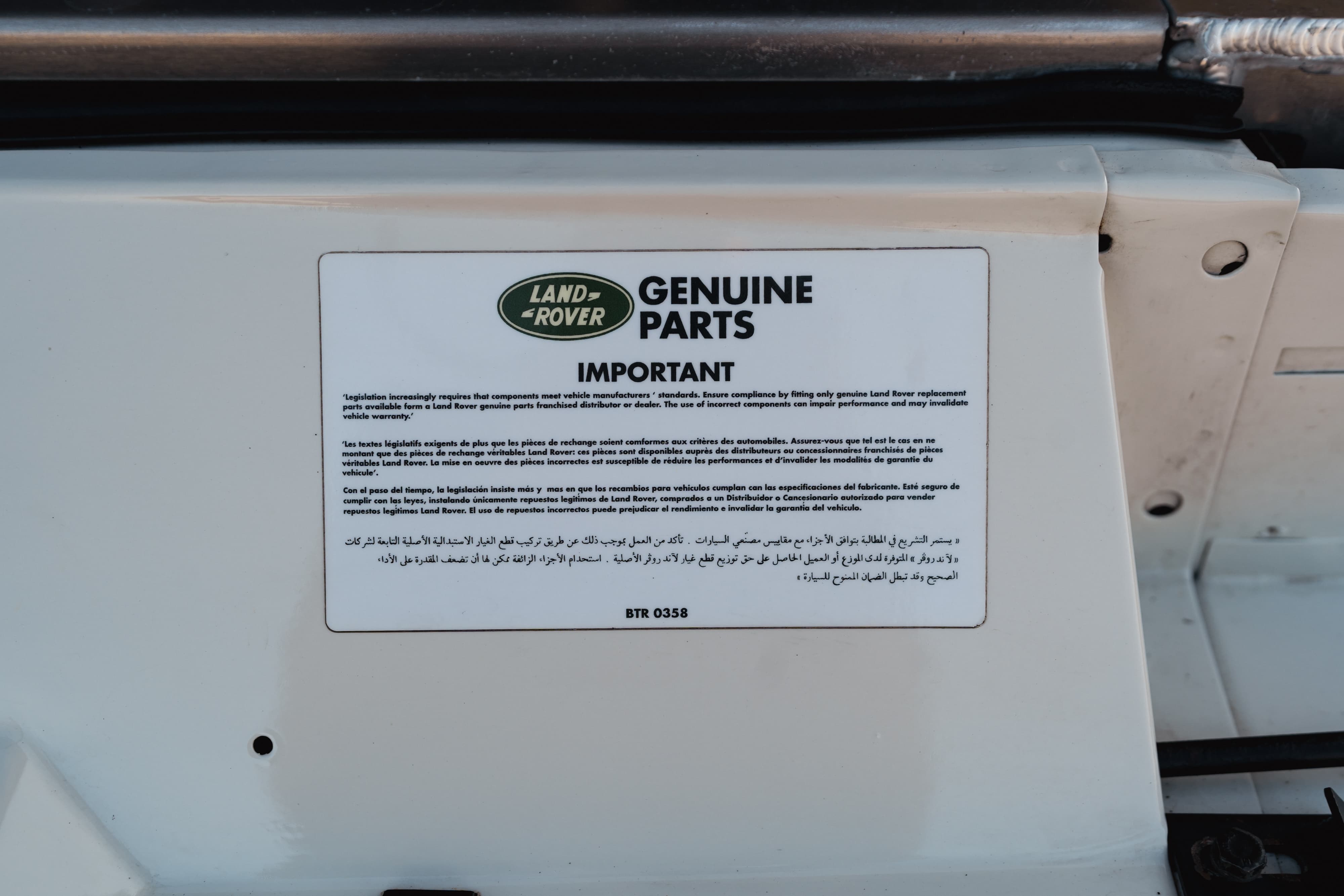 Engine bay stickers on a 1995 White Land Rover Range Rover County Long Wheel Base in Austin, TX.