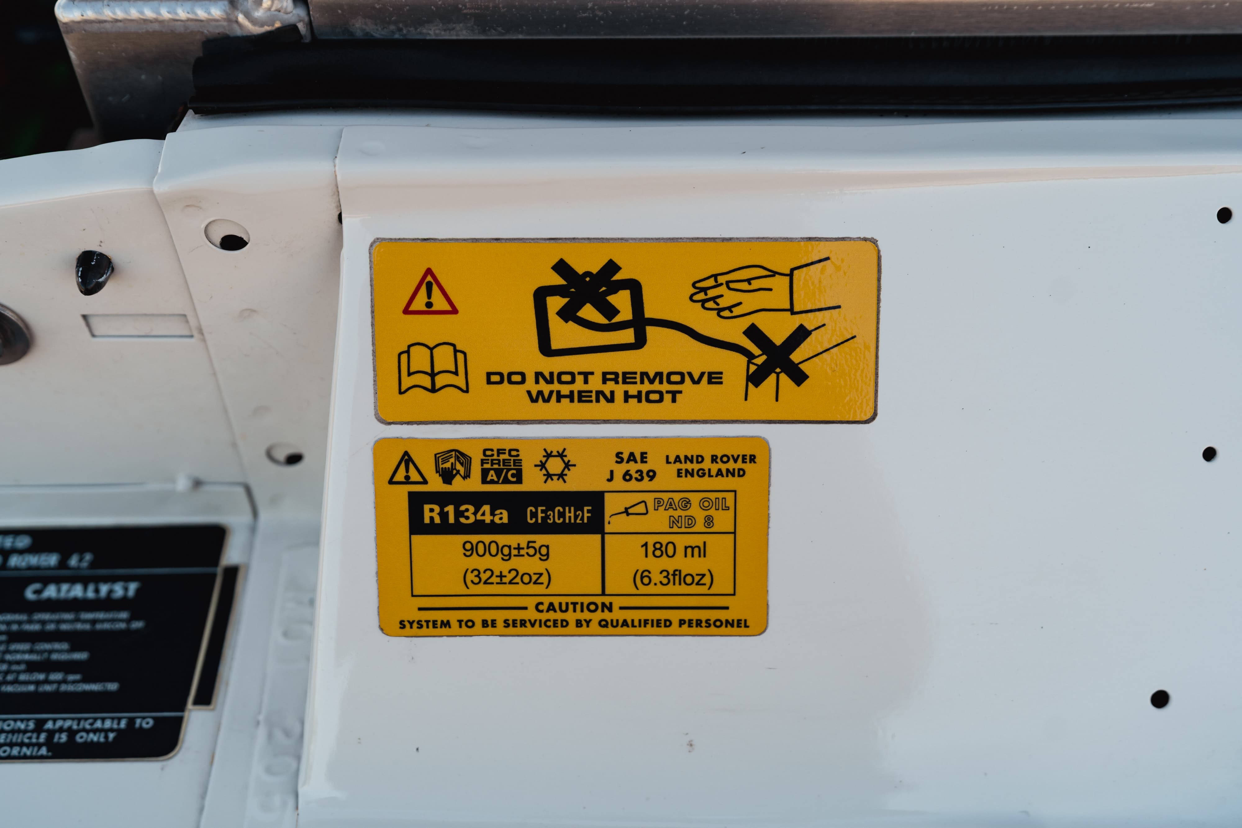 Engine bay stickers on a 1995 White Land Rover Range Rover County Long Wheel Base in Austin, TX.