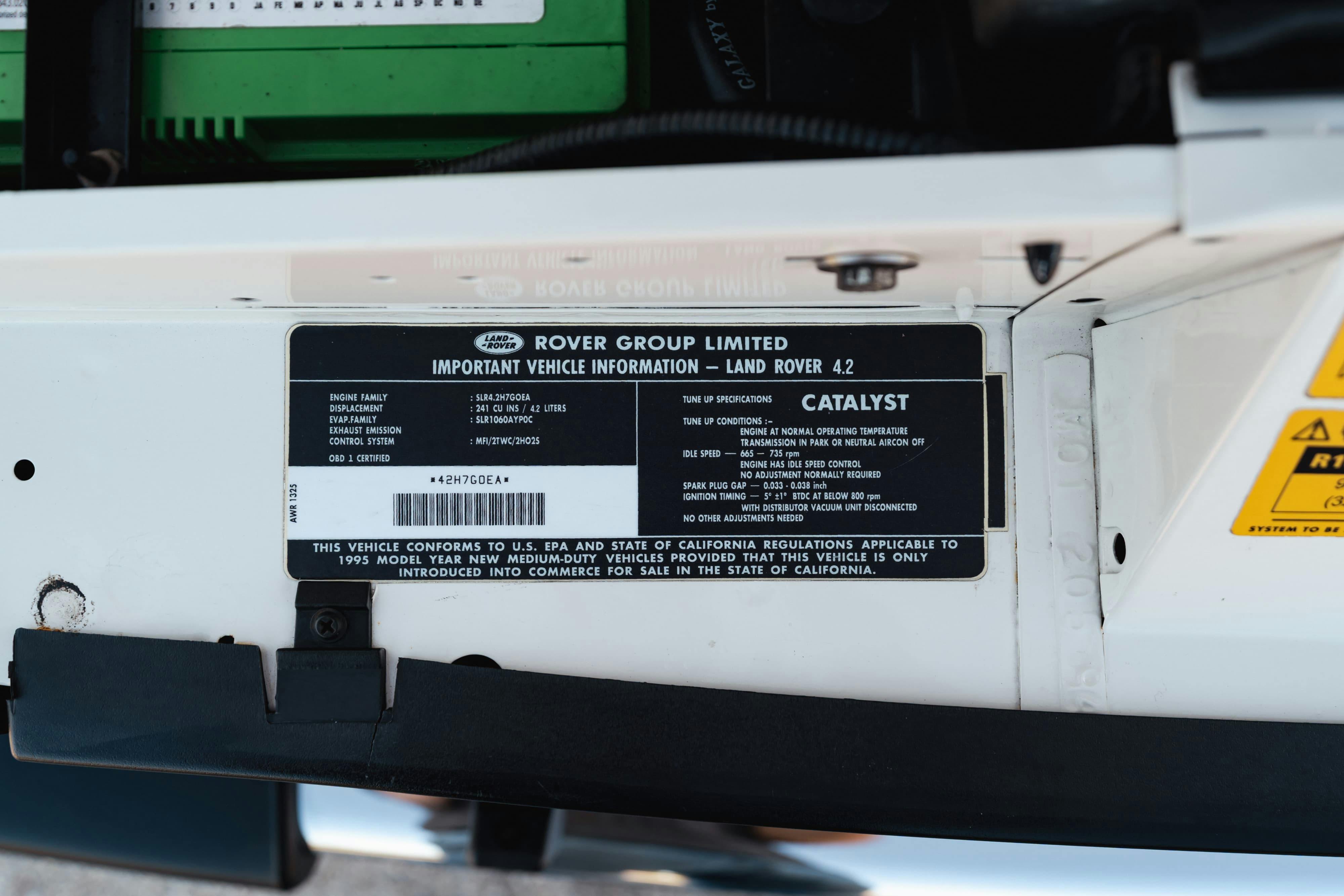 Engine bay stickers on a 1995 White Land Rover Range Rover County Long Wheel Base in Austin, TX.
