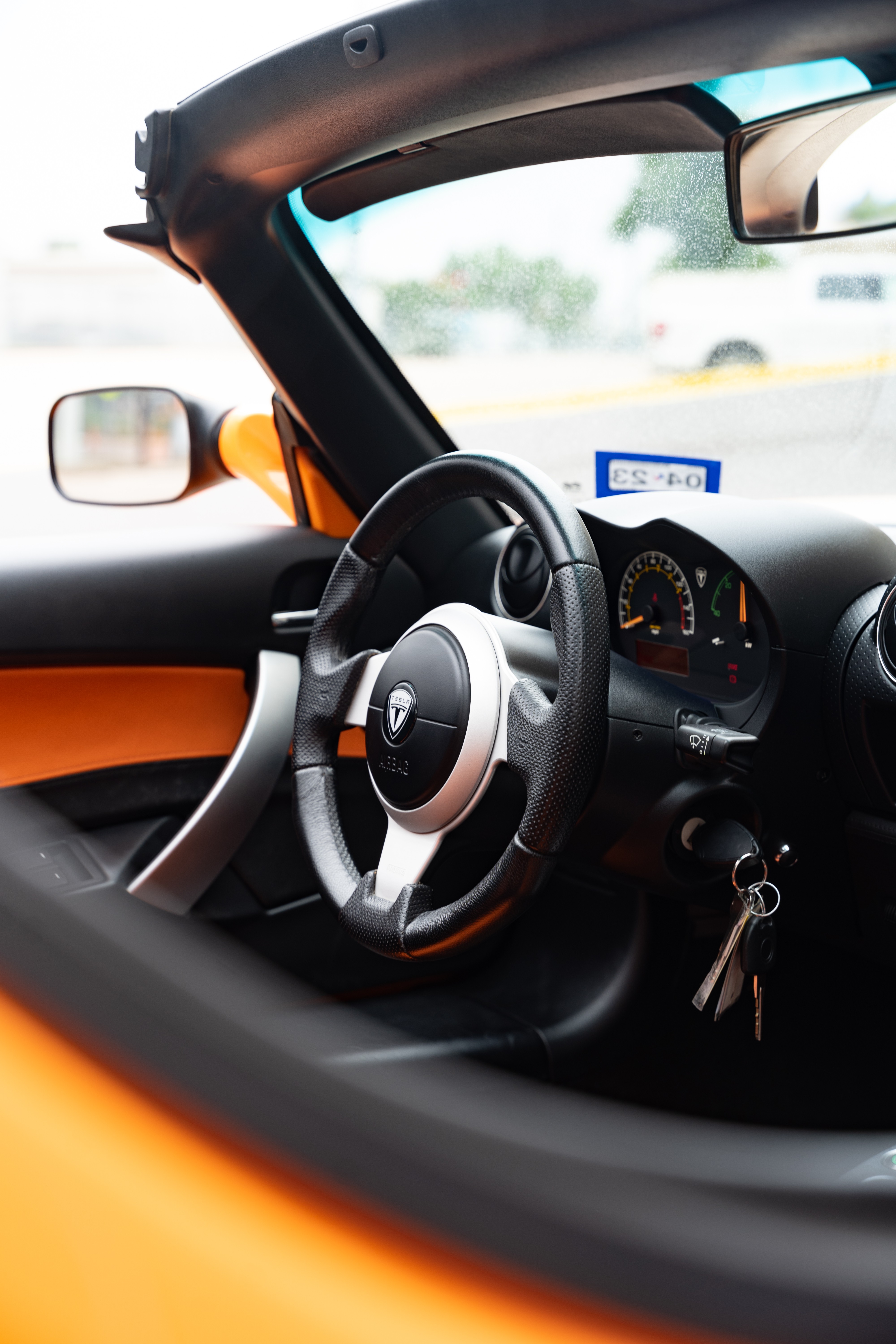 Black interior on a 2010 Very Orange Metallic Tesla Roadster in Austin, TX.