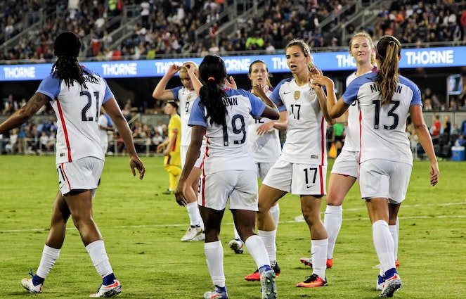 U.S. Women's Soccer team players celebrate after scoring a goal during a match