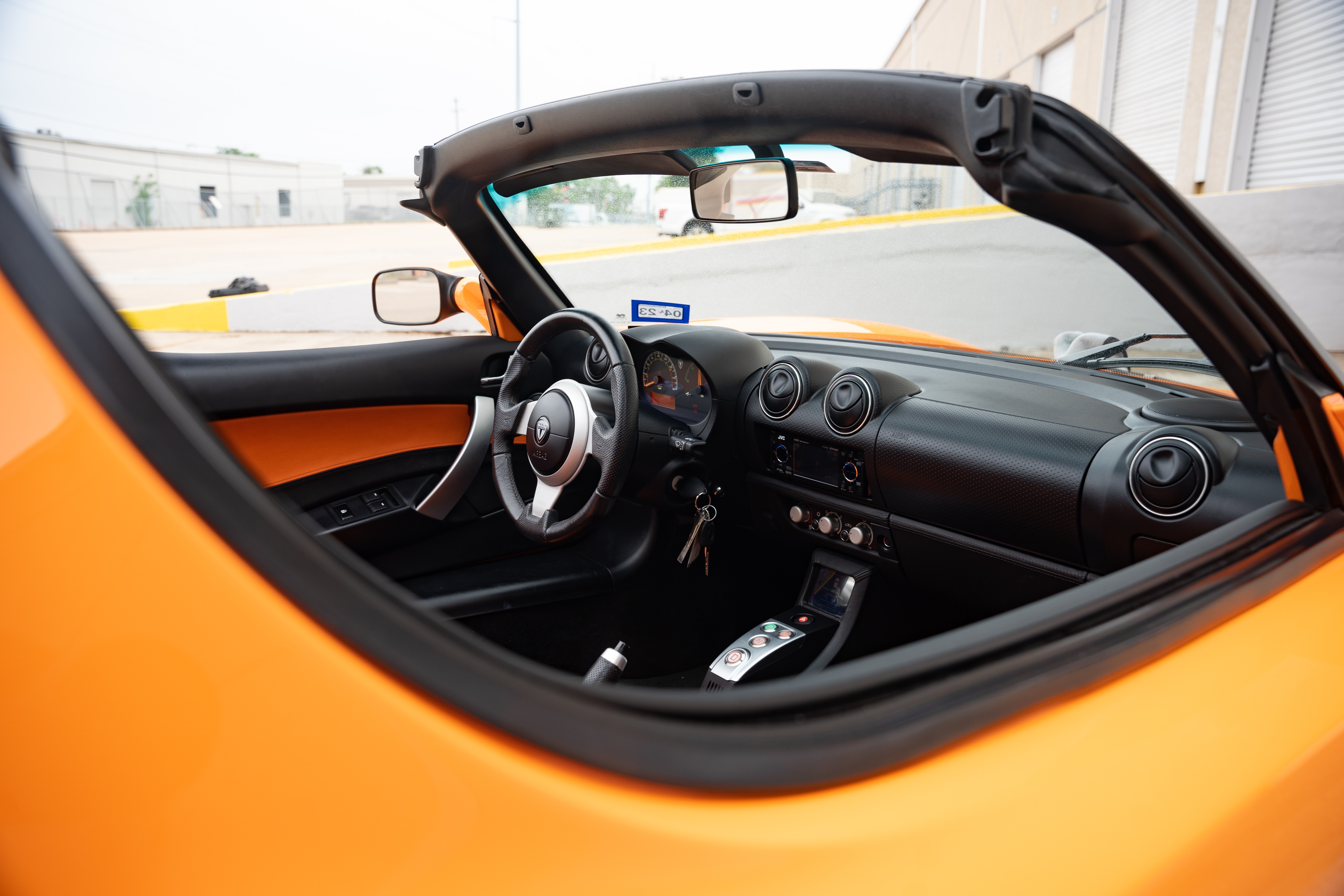 Black interior on a 2010 Very Orange Metallic Tesla Roadster in Austin, TX.