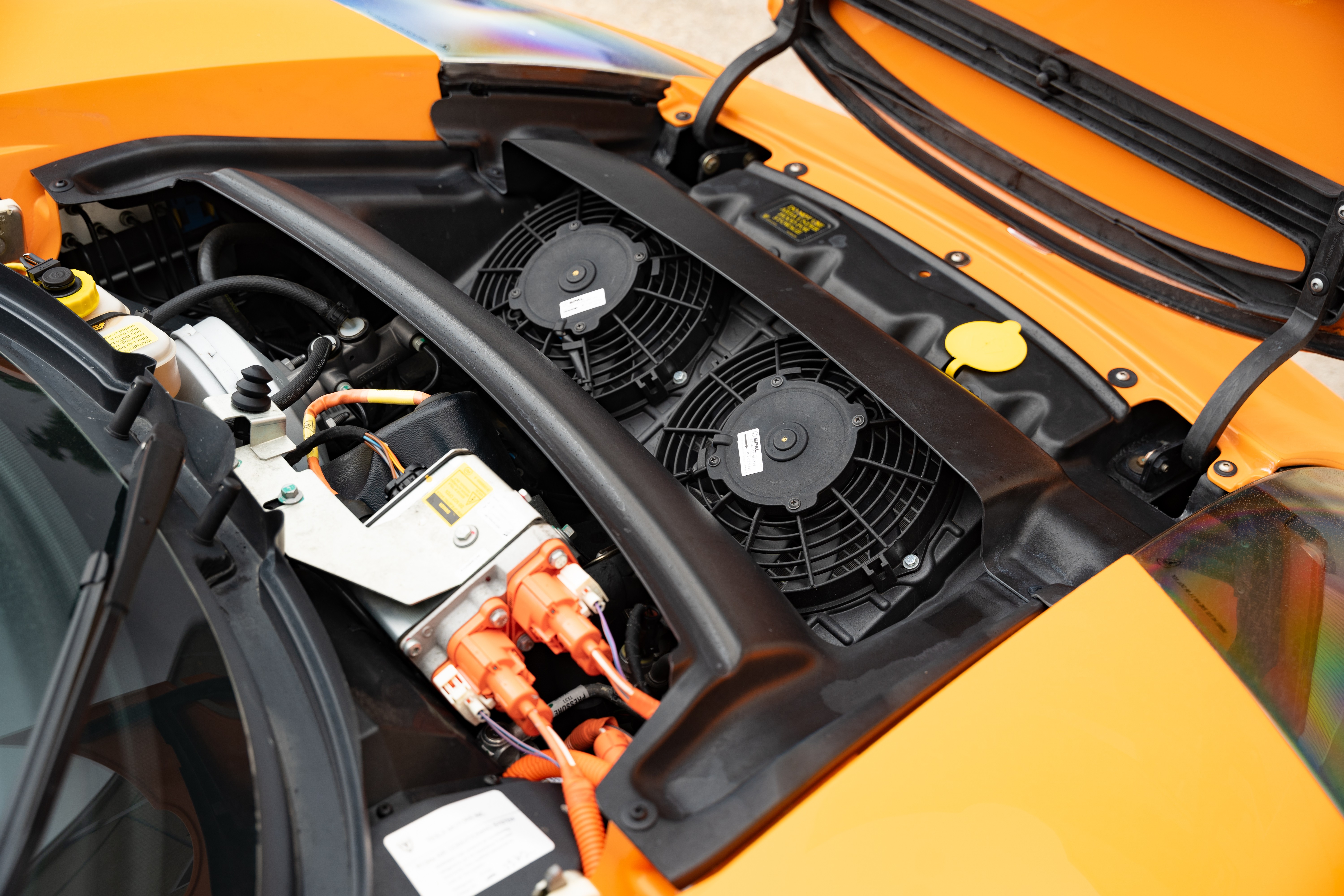 Charging port on a 2010 Very Orange Metallic Tesla Roadster in Austin, TX.