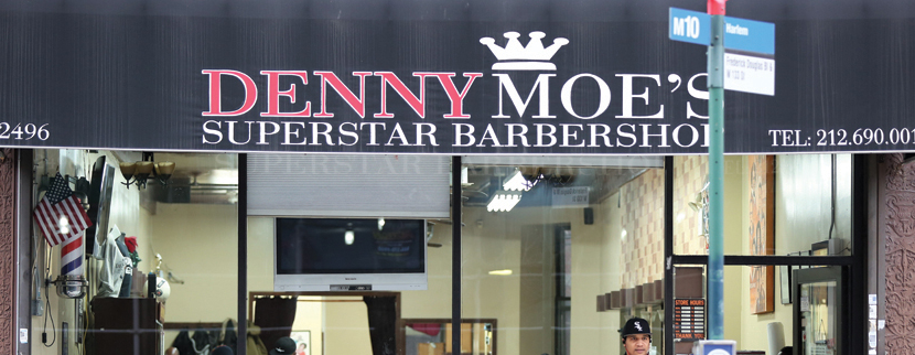 Storefront of Denny Moe's Superstar Barbershop in Harlem, NYC.