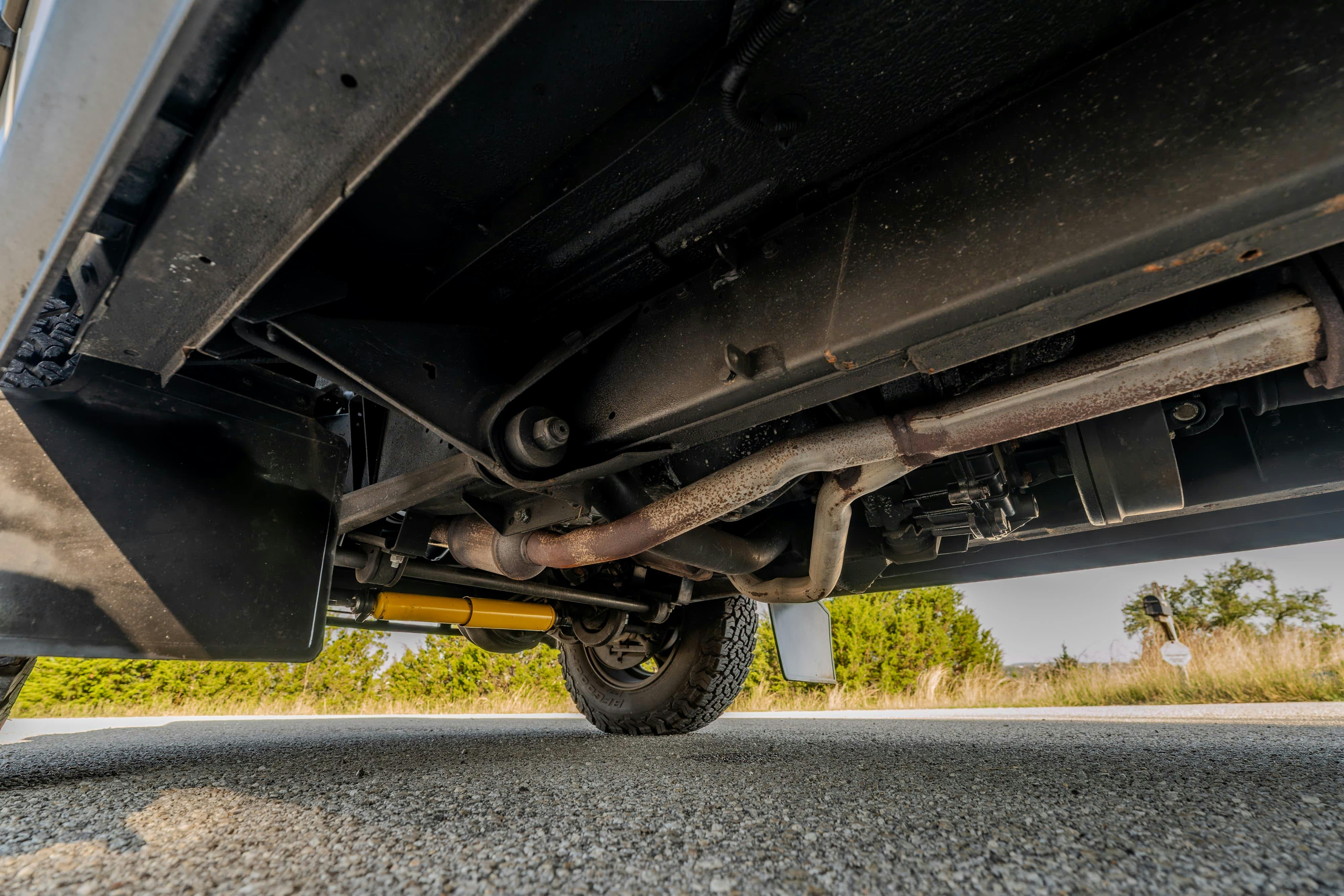 Undercarriage of a 1995 White Land Rover Range Rover County Long Wheel Base in Austin, TX.