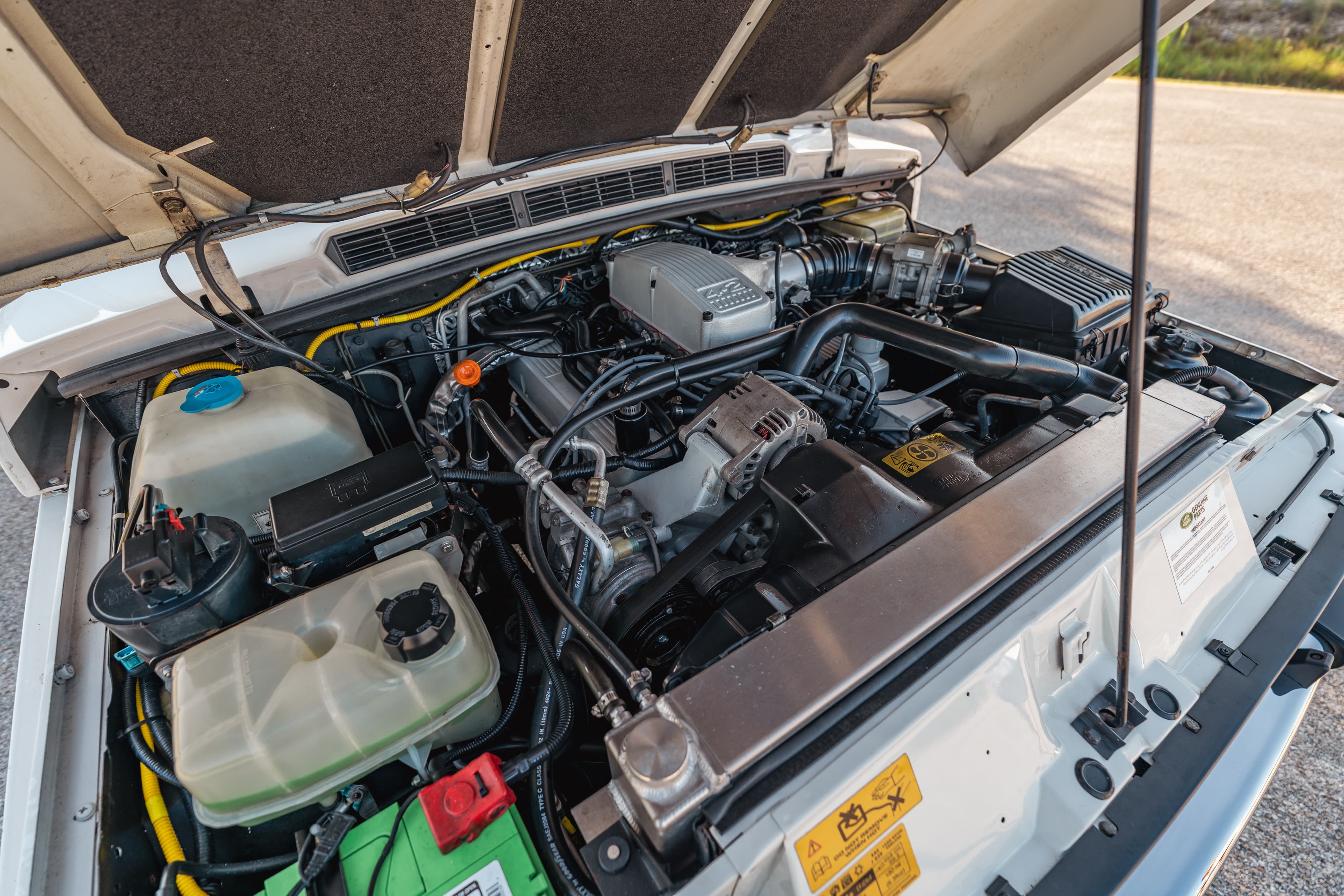 Engine bay of a 4.6 swapped 1995 White Land Rover Range Rover County Long Wheel Base in Austin, TX.