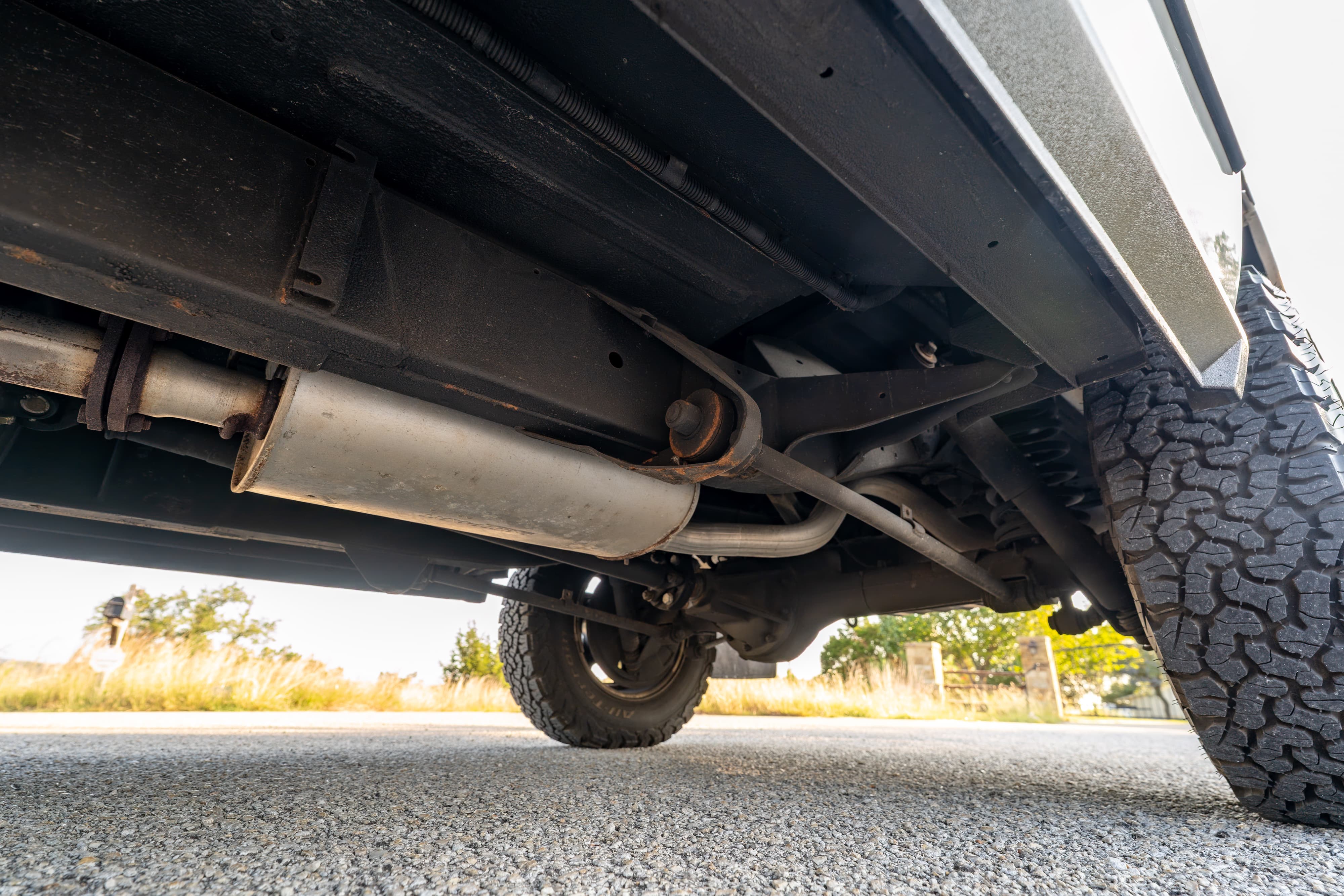 Undercarriage of a 1995 White Land Rover Range Rover County Long Wheel Base in Austin, TX.
