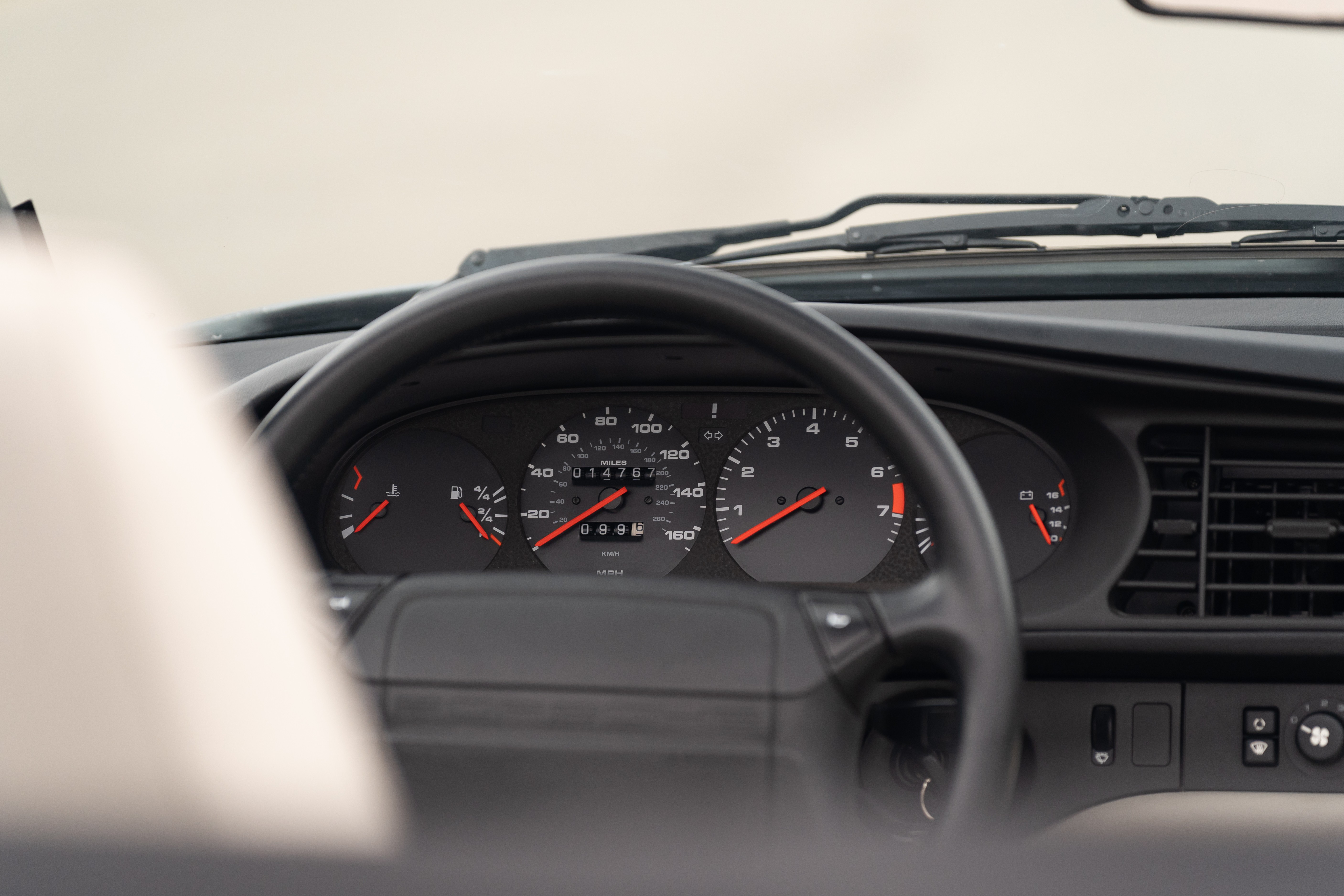 Gauge cluster on a Titanium Metallic 1990 Porsche 944 S2 Cabriolet 5-Speed shot in Austin, TX.