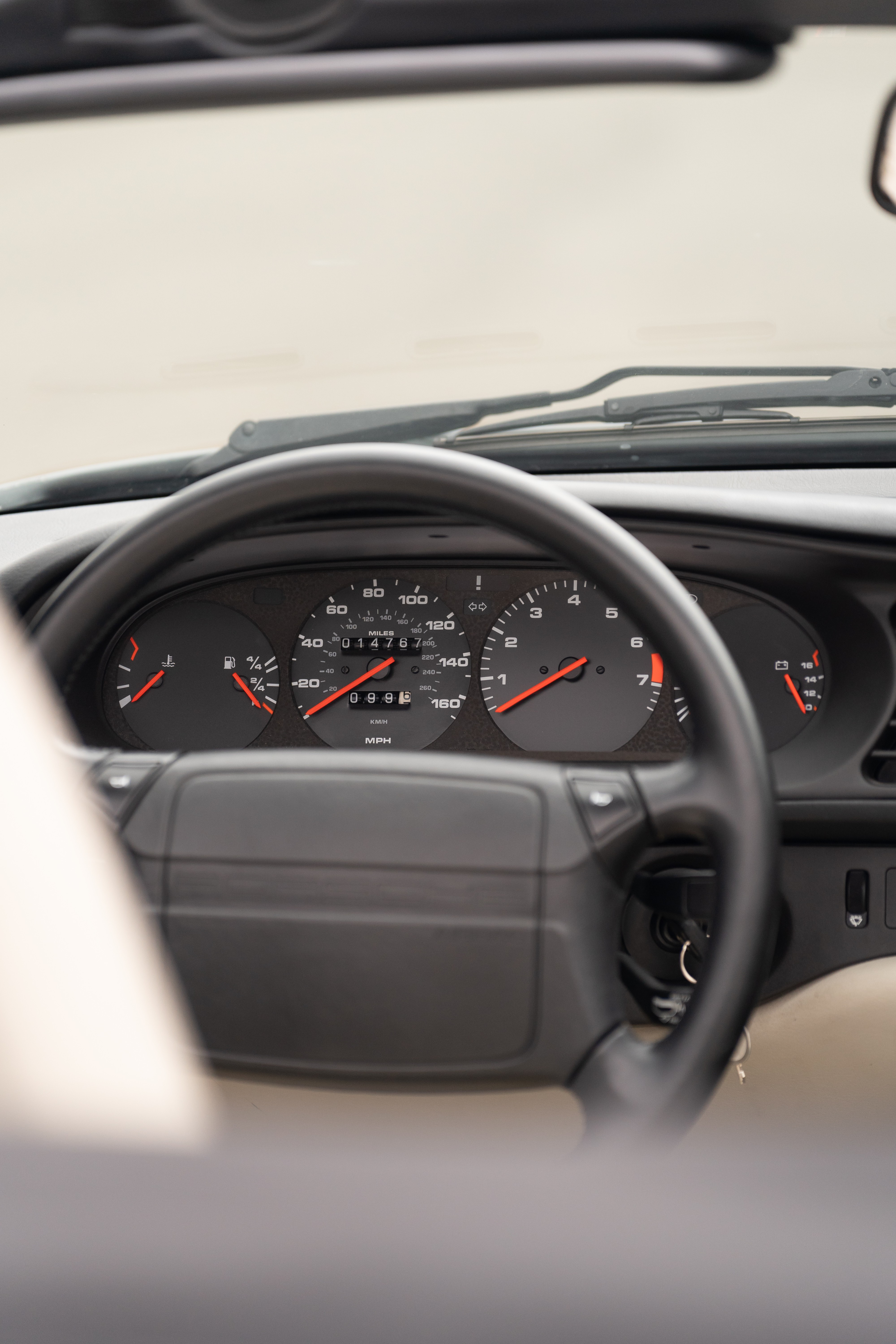 Gauge cluster on a Titanium Metallic 1990 Porsche 944 S2 Cabriolet 5-Speed shot in Austin, TX.