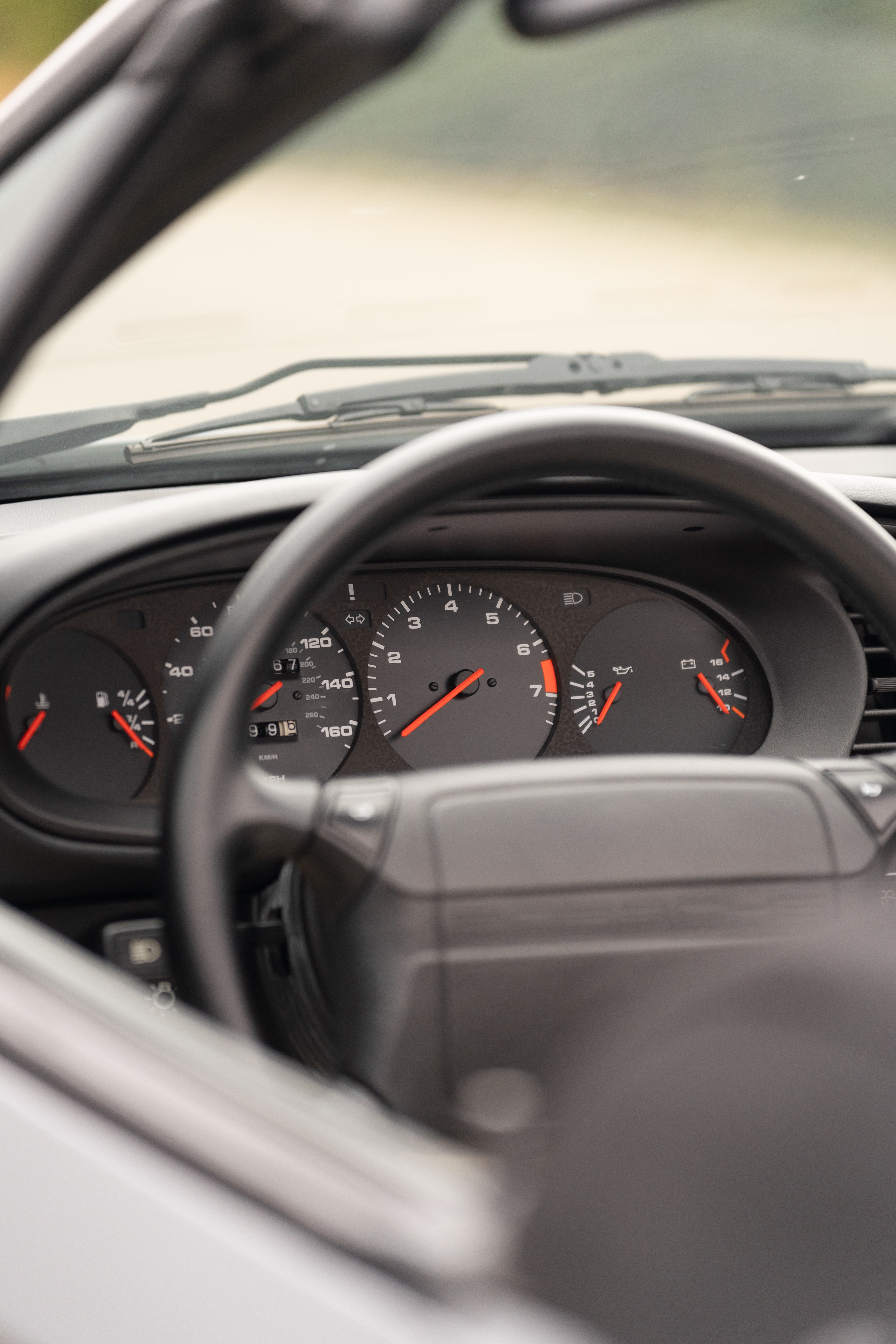 Gauge cluster on a Titanium Metallic 1990 Porsche 944 S2 Cabriolet 5-Speed shot in Austin, TX.