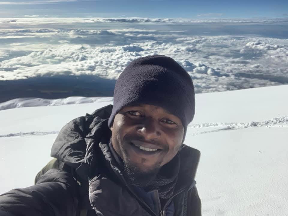 Local-guide-Joseph-Paul-at-the-snowy-summit-of-Kilimanjaro---The-Adventure-People.jpg