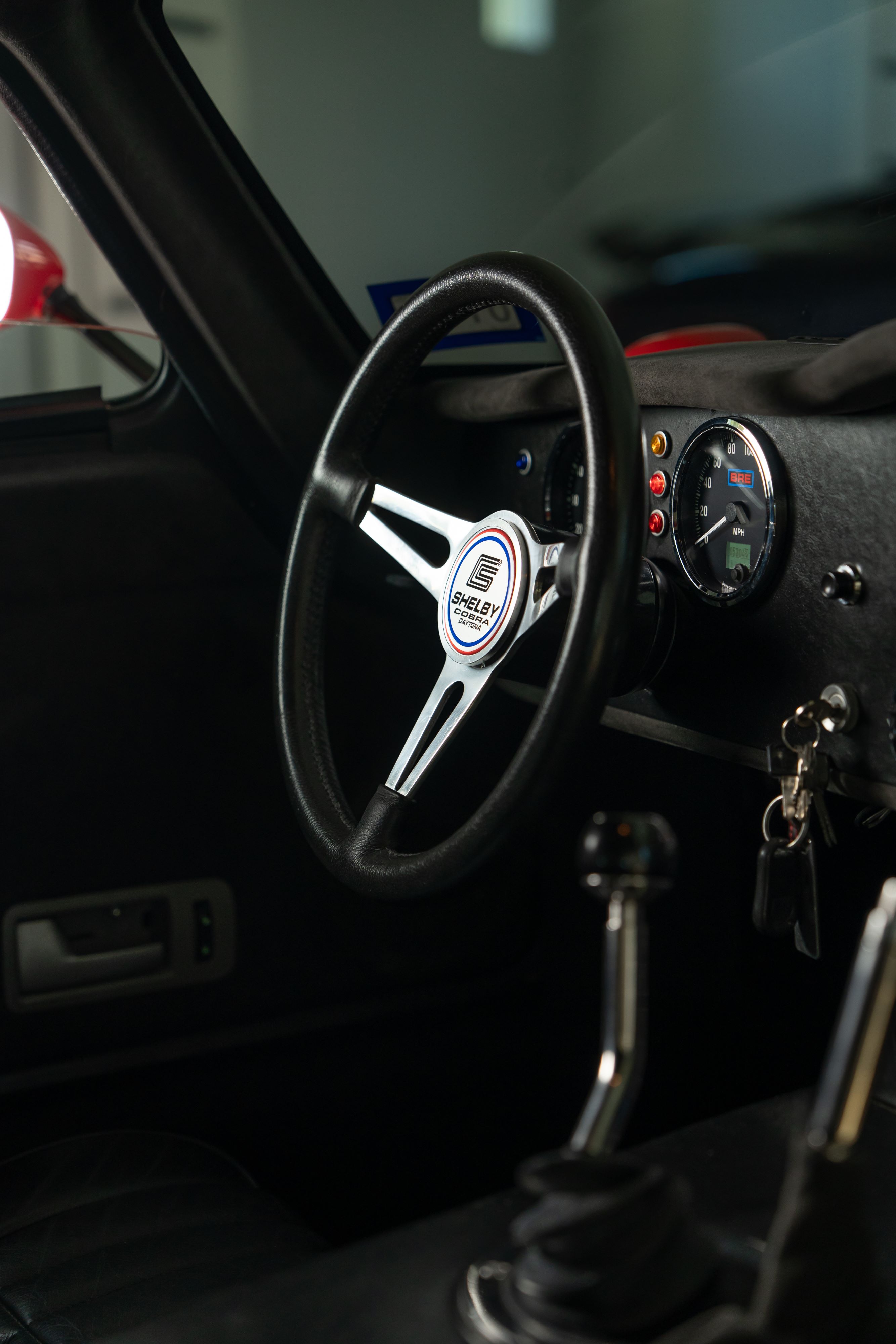 Interior of a 1965 Superformance Shelby Daytona CSX9000 in Monza Red.