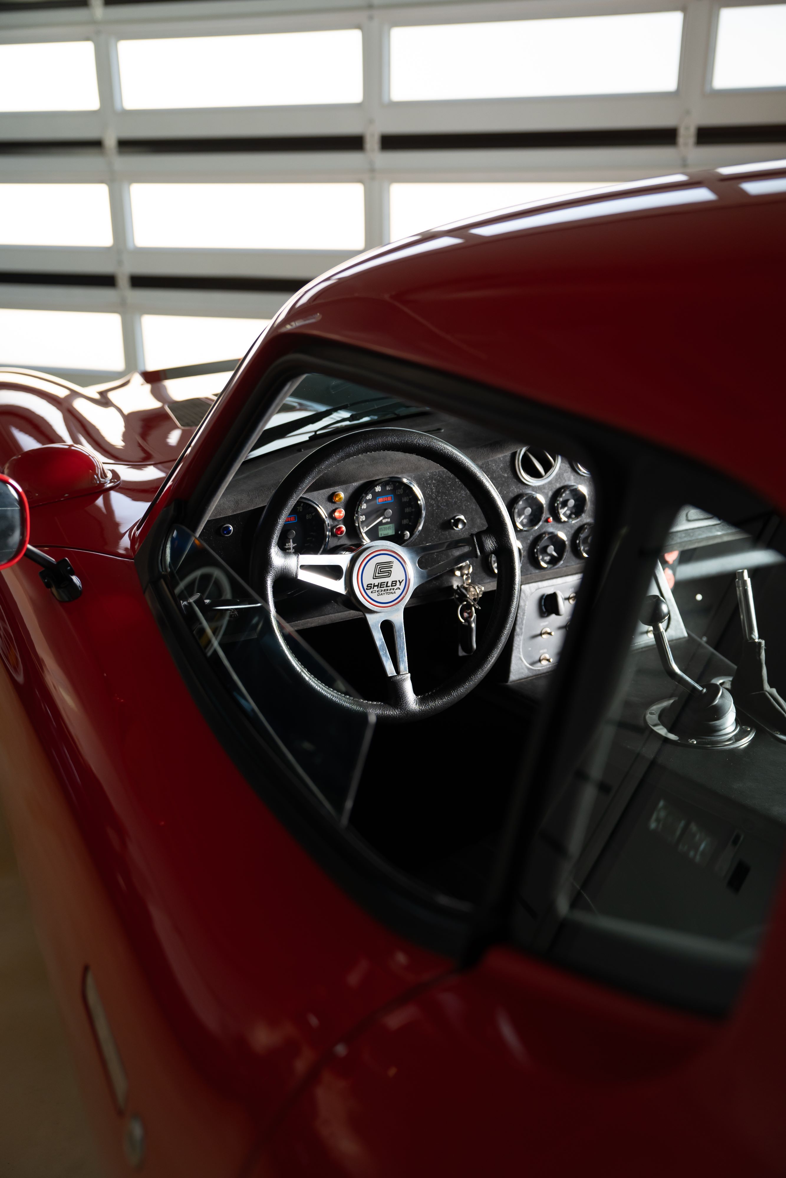 Interior of a 1965 Superformance Shelby Daytona CSX9000 in Monza Red.